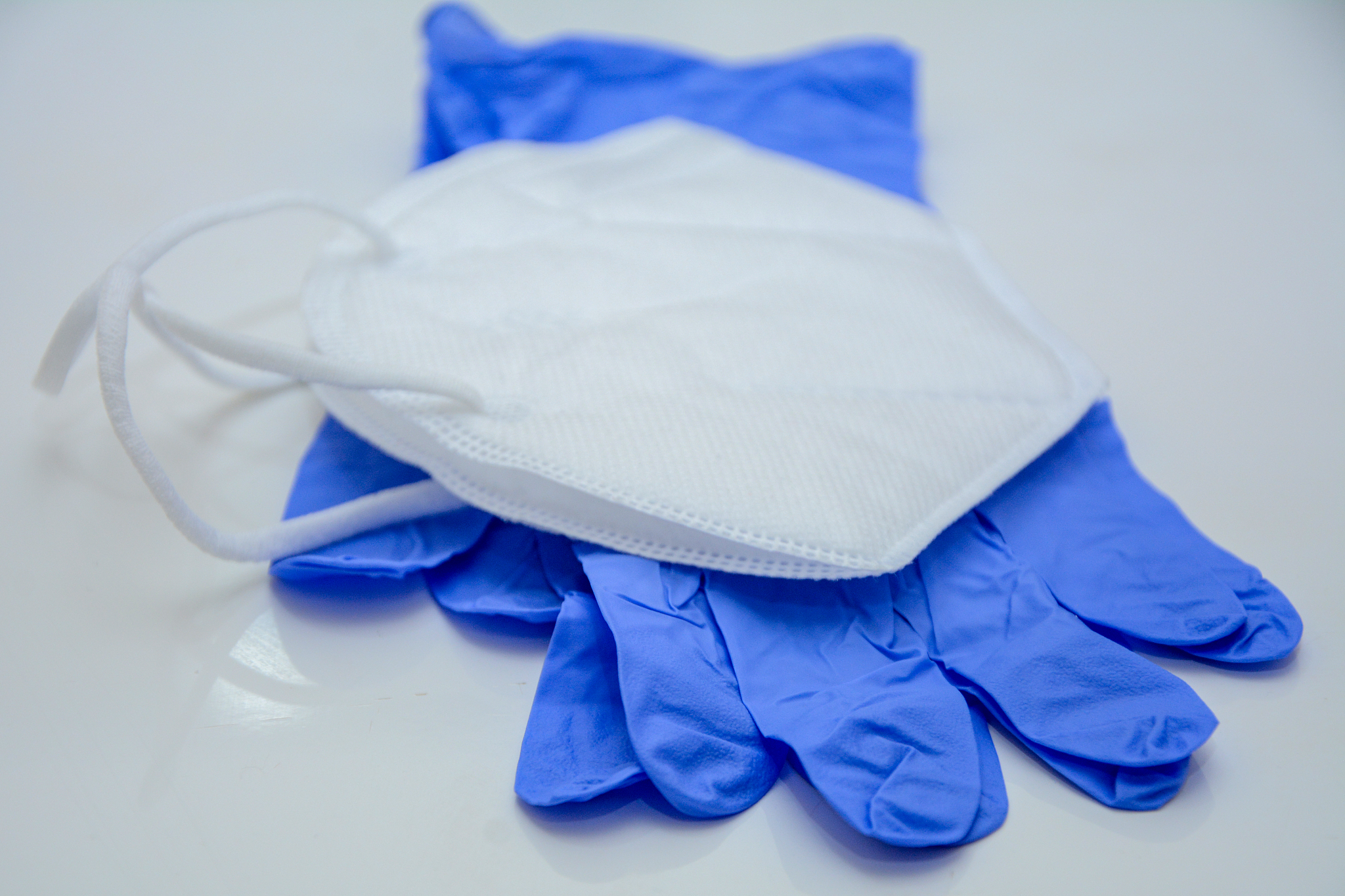 n95 mask and surgical glove on white background