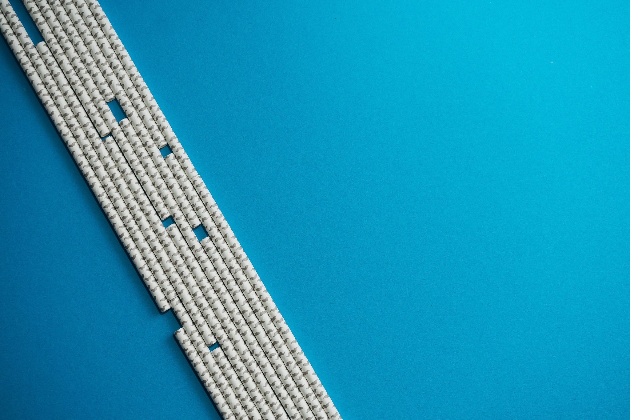 paper straws on blue background
