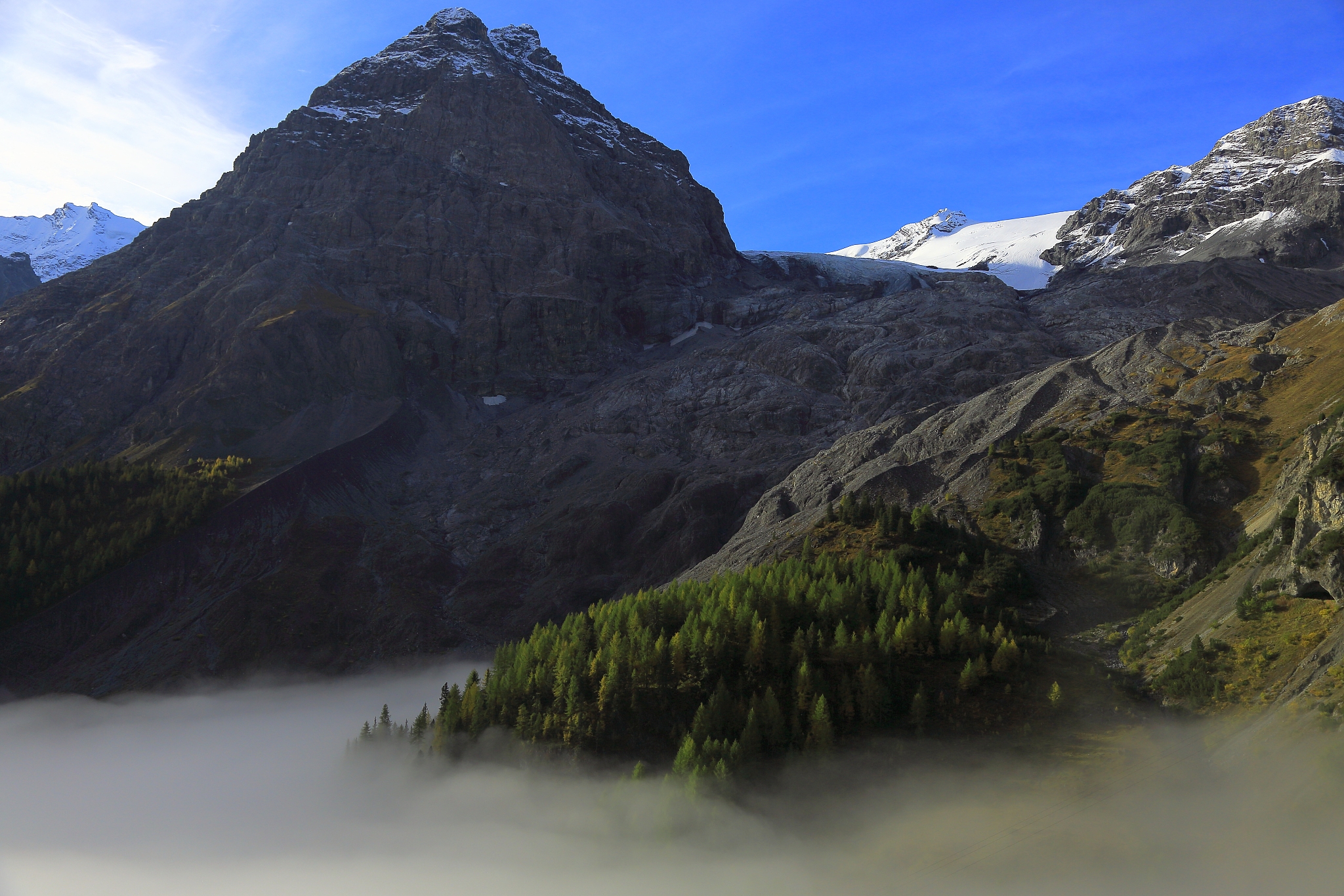 alpine landscape over mist - dolomites alps, italy