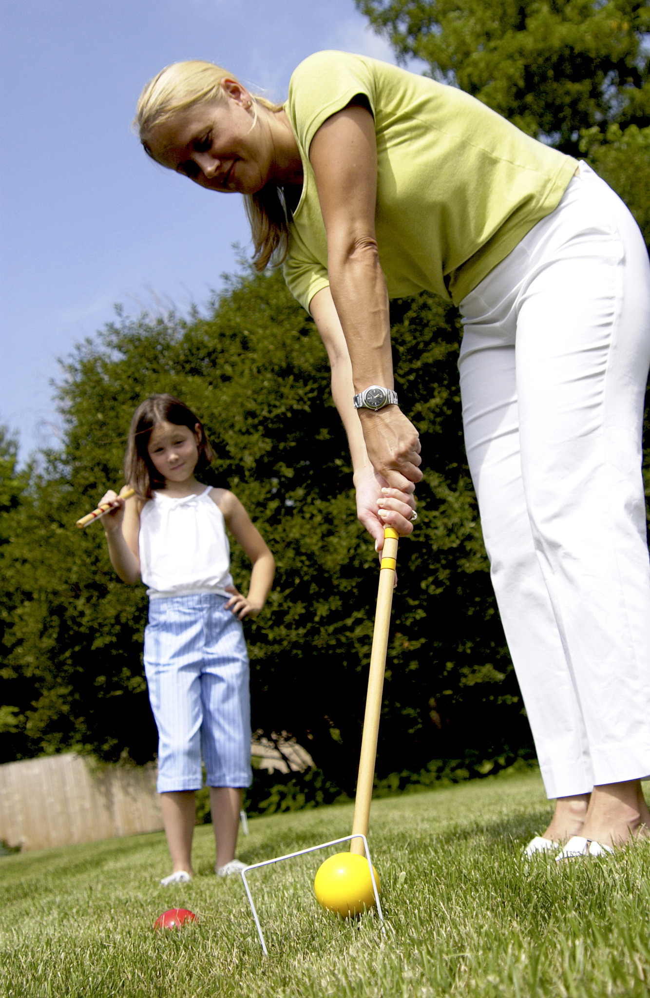 mother and daughter playing croquet