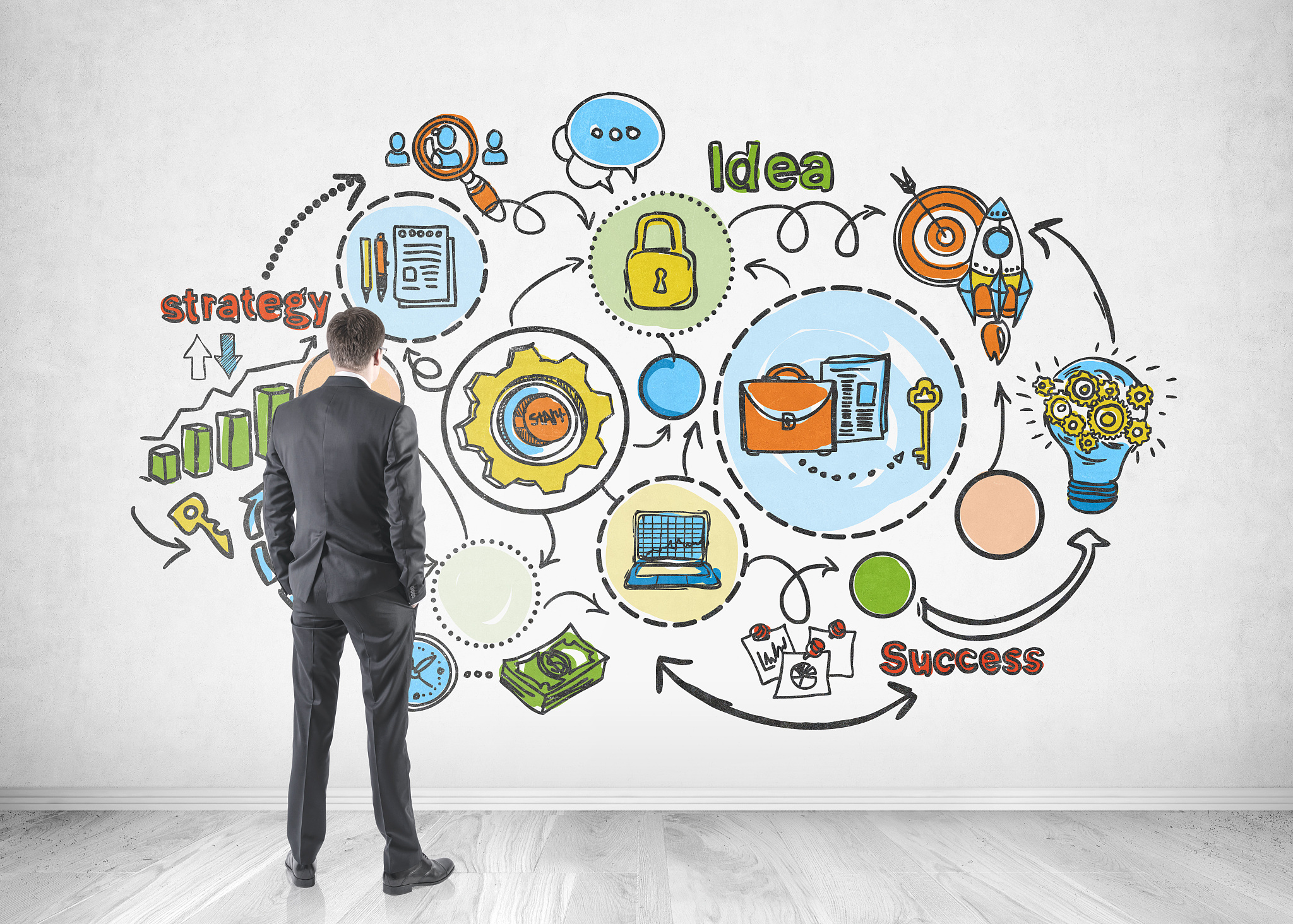 businessman looking at business plan drawing