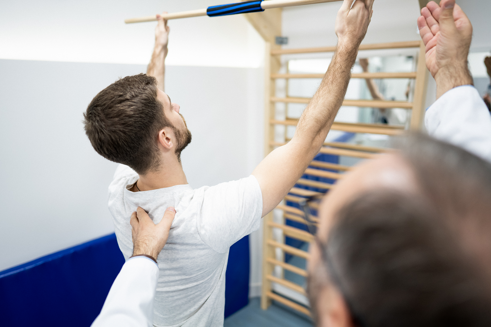 physiotherapist corrects the posture of his patient, which is ve