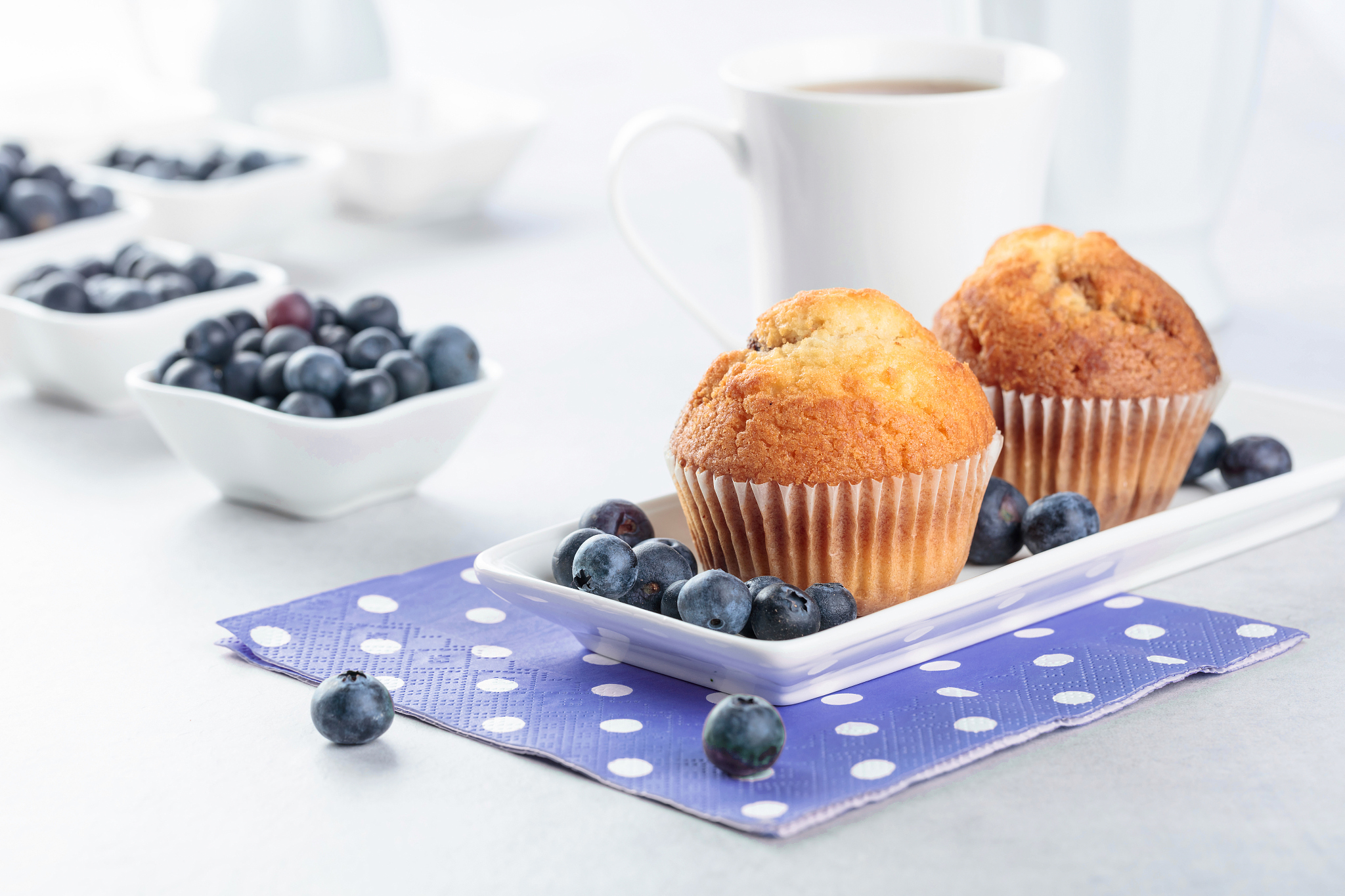 muffins and blueberry on white table.