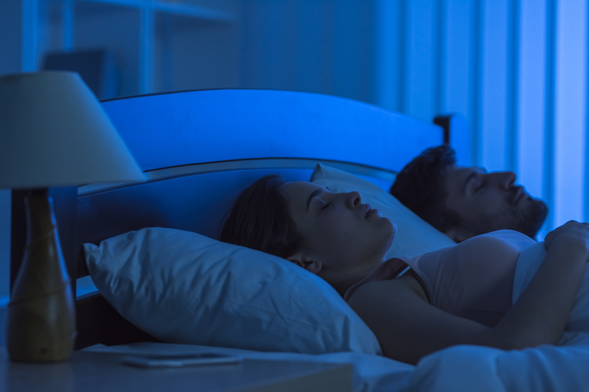 the young couple sleeping in the bed. night time