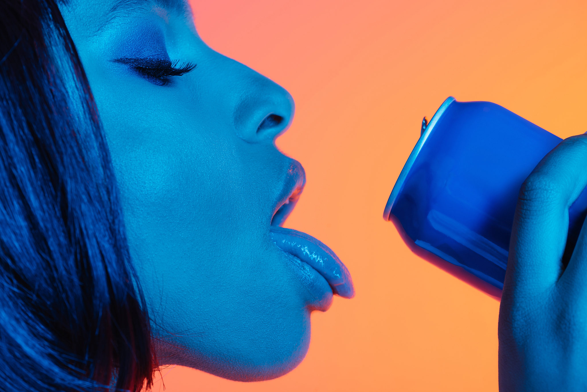 sensual african american girl drinking from can with loll out