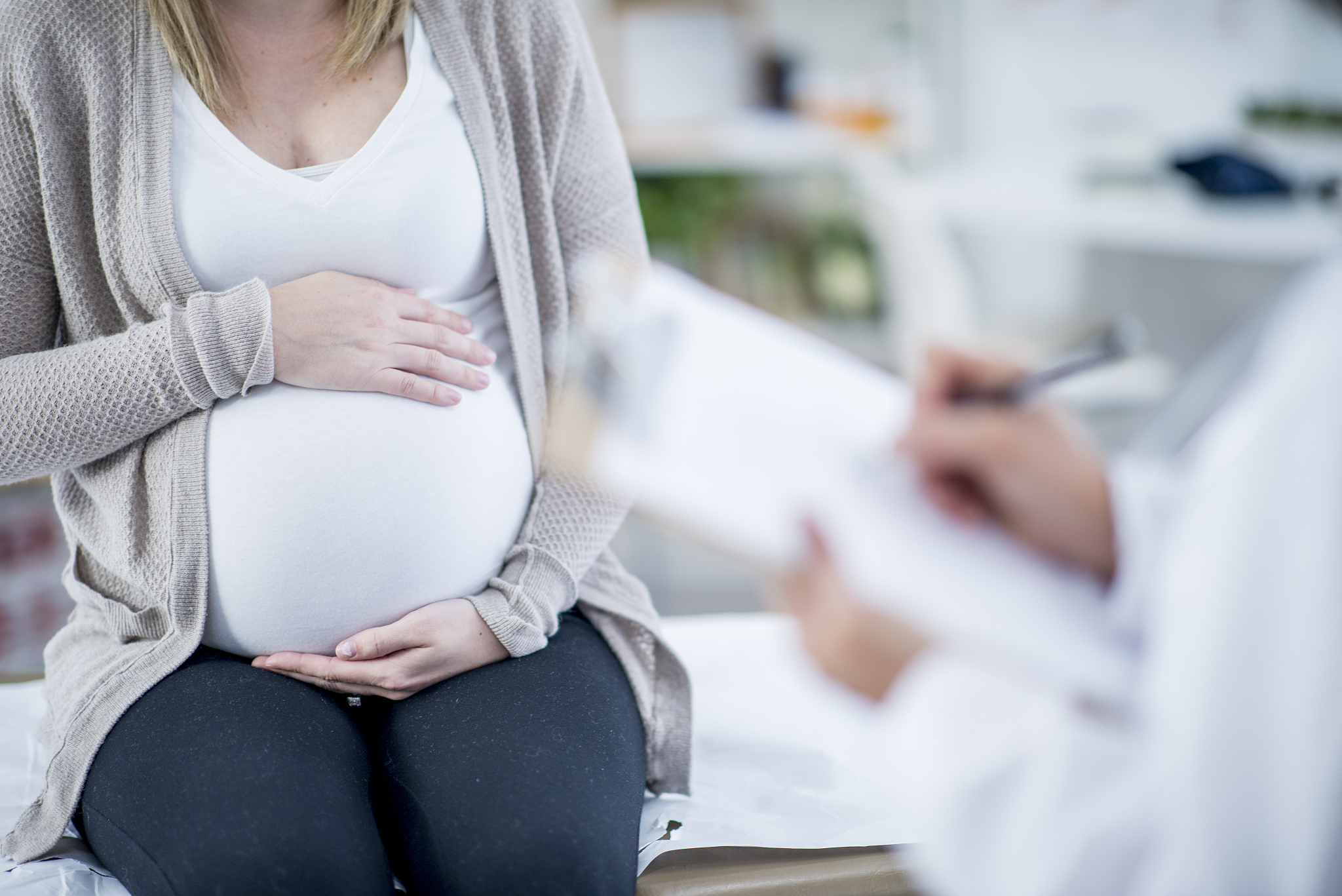 pregnant woman holding stomach