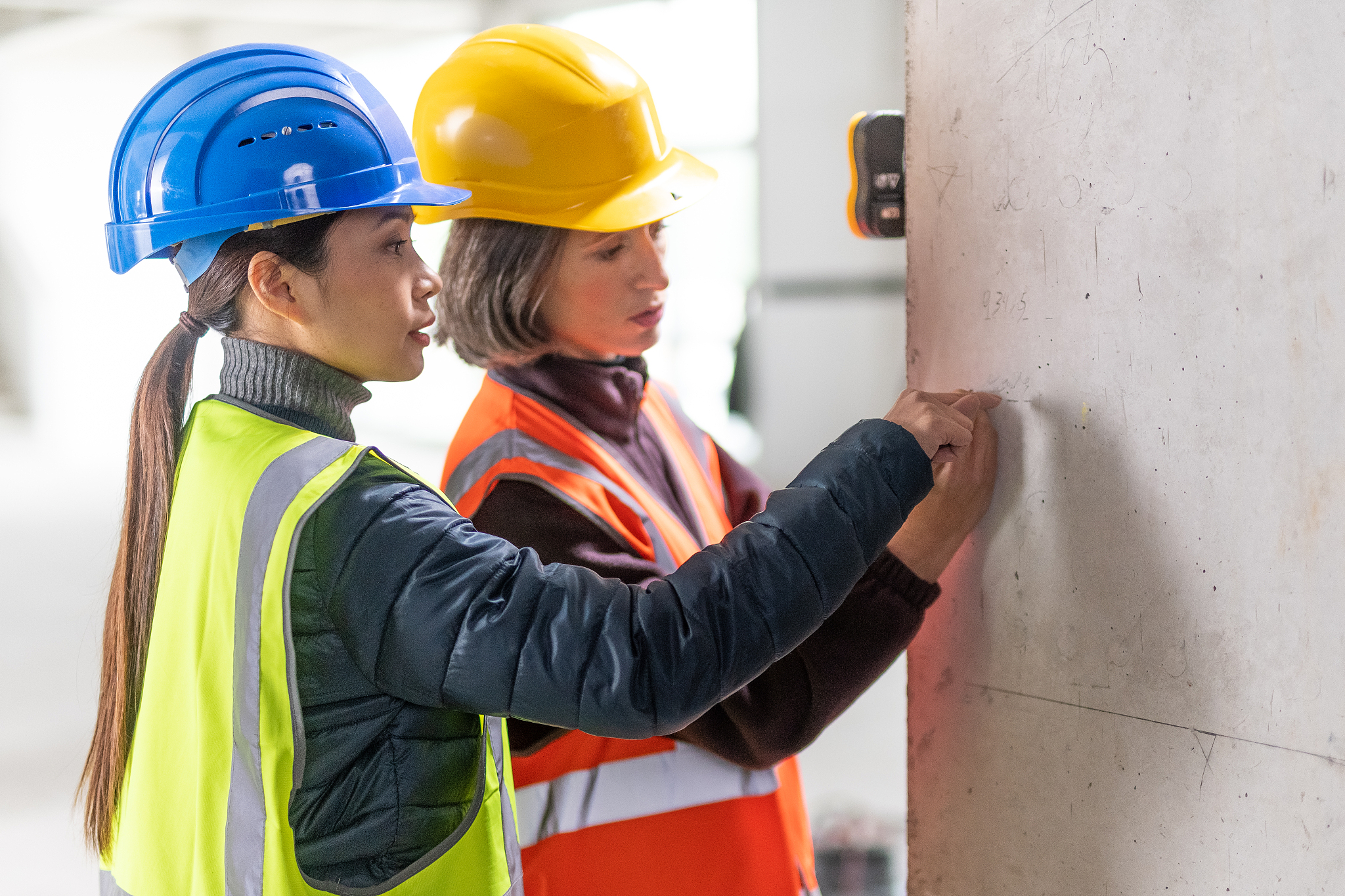 construction workers doing measurements on a construction site