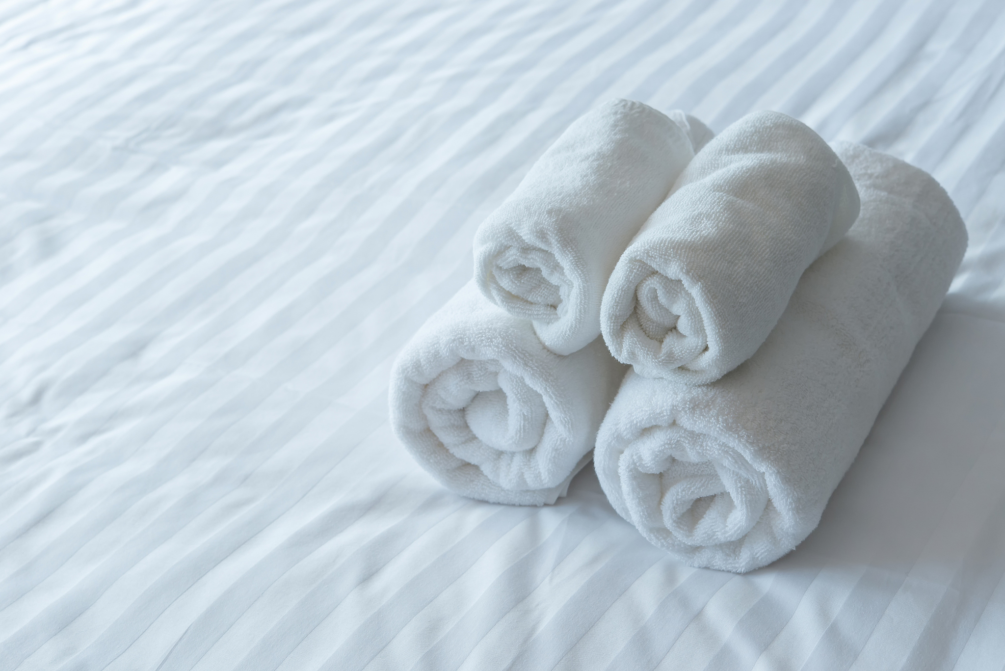 white bath towels in bed room, room service