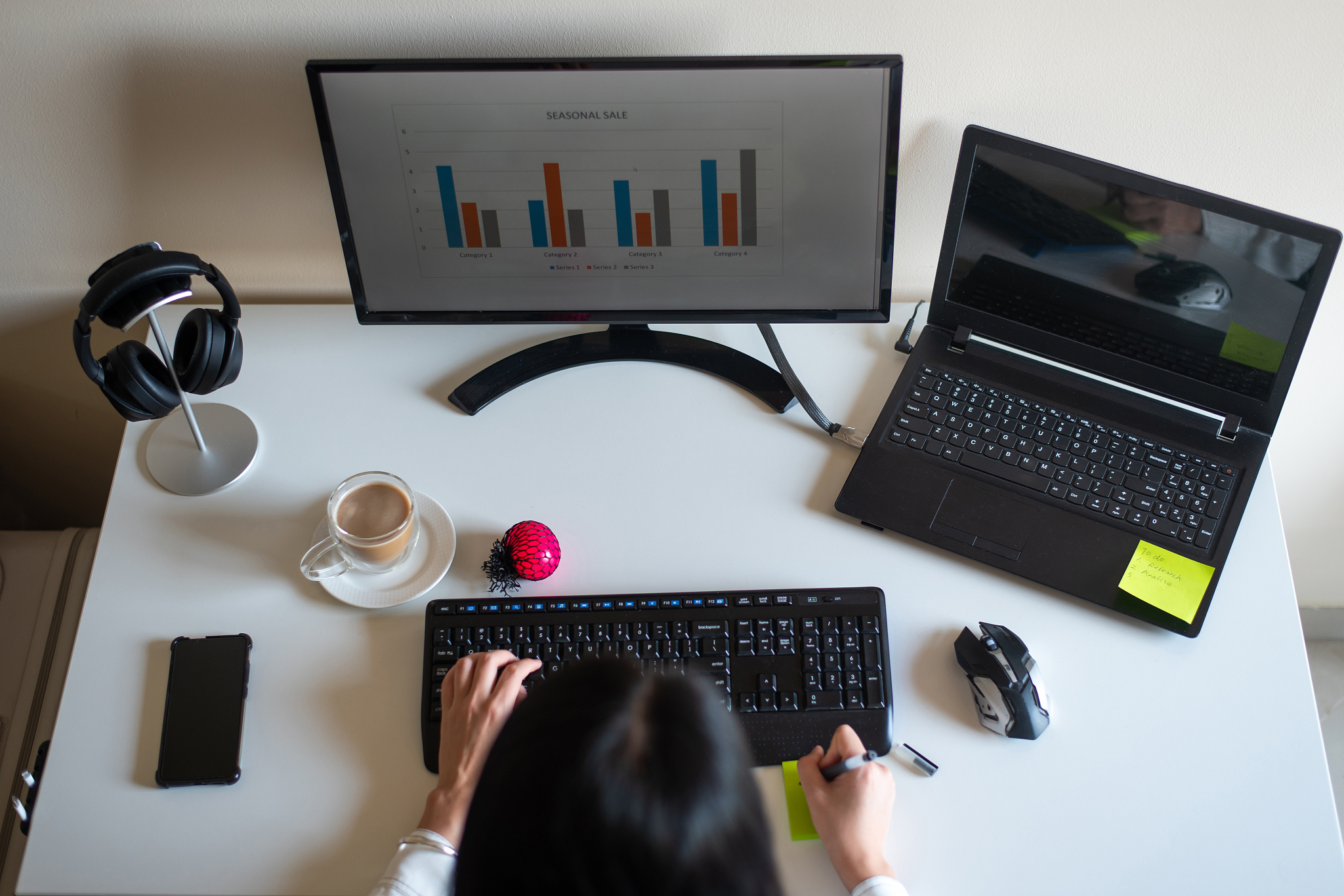woman working on a white desk at home office