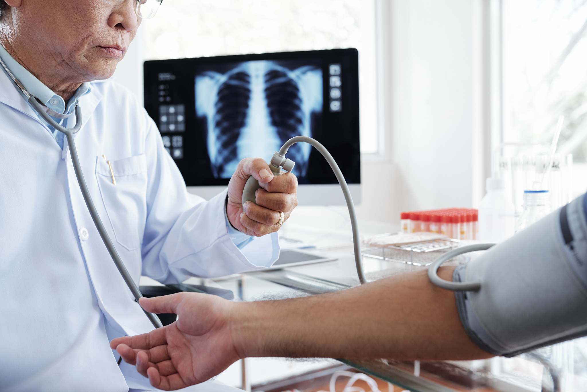 doctor checking arterial blood pressure