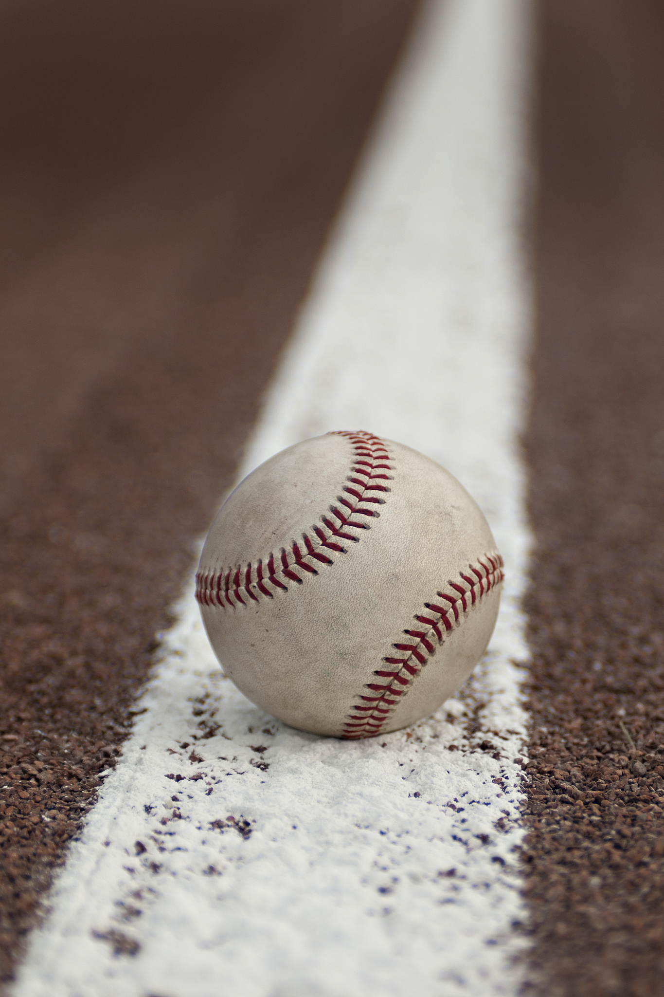 baseball resting on a baseline.