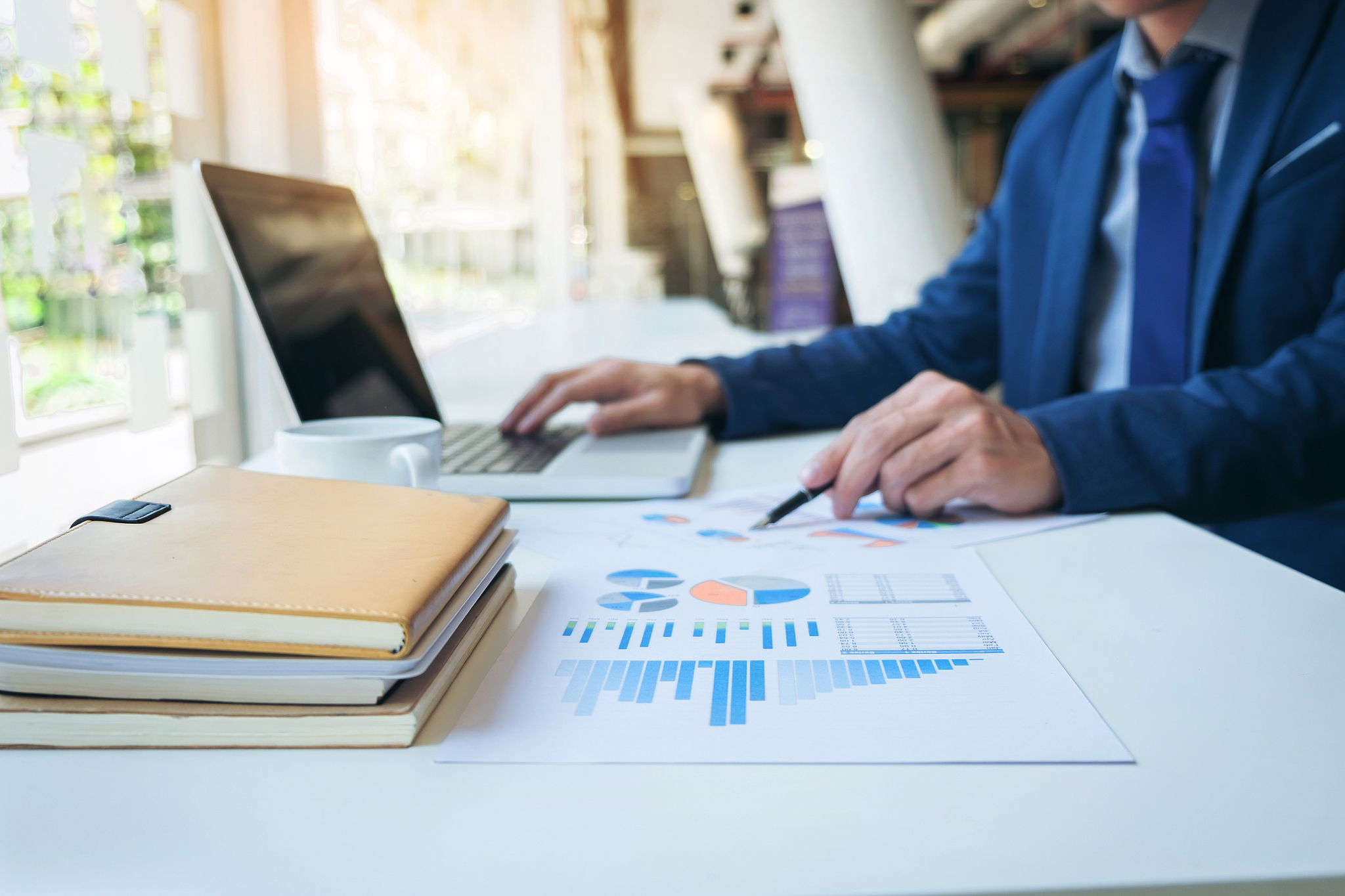 business man working at office with laptop and documents on his 