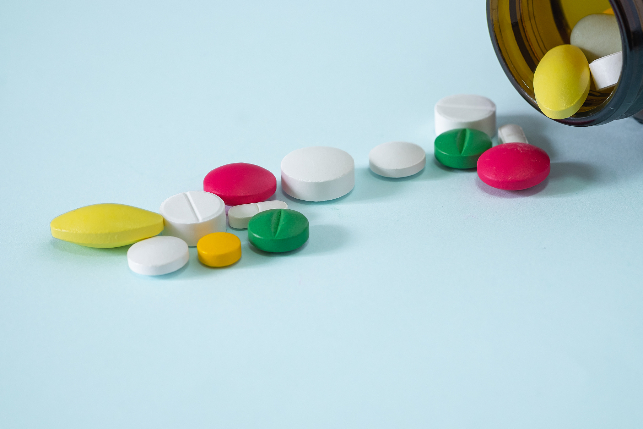 colorful, assorted pharmaceutical medicine pills poured out of t