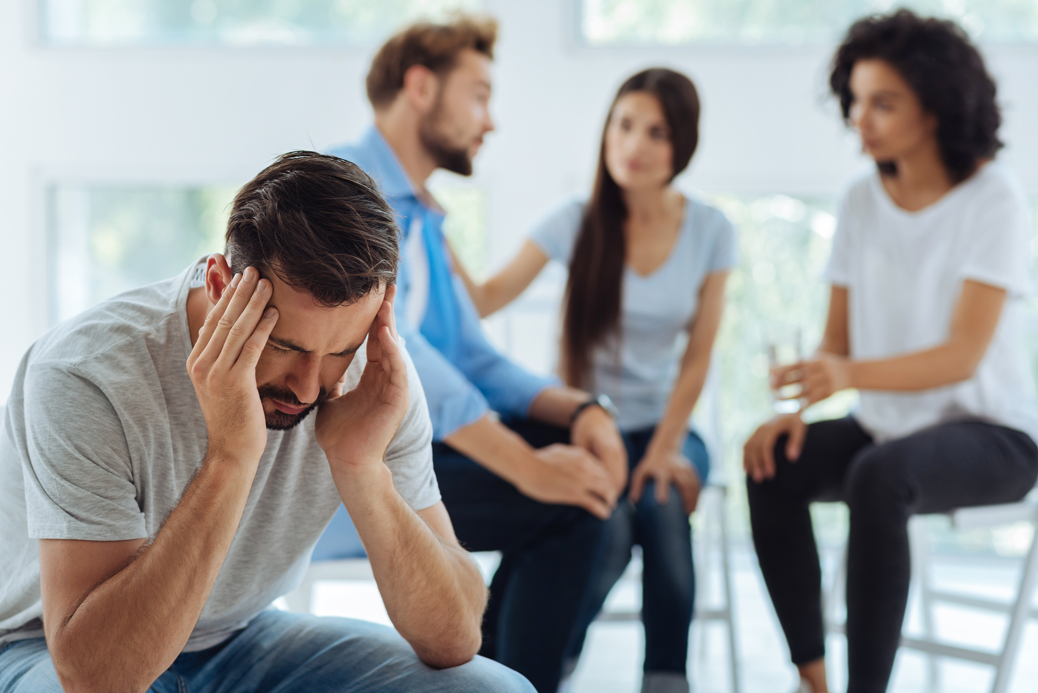 depressed moody man holding his head