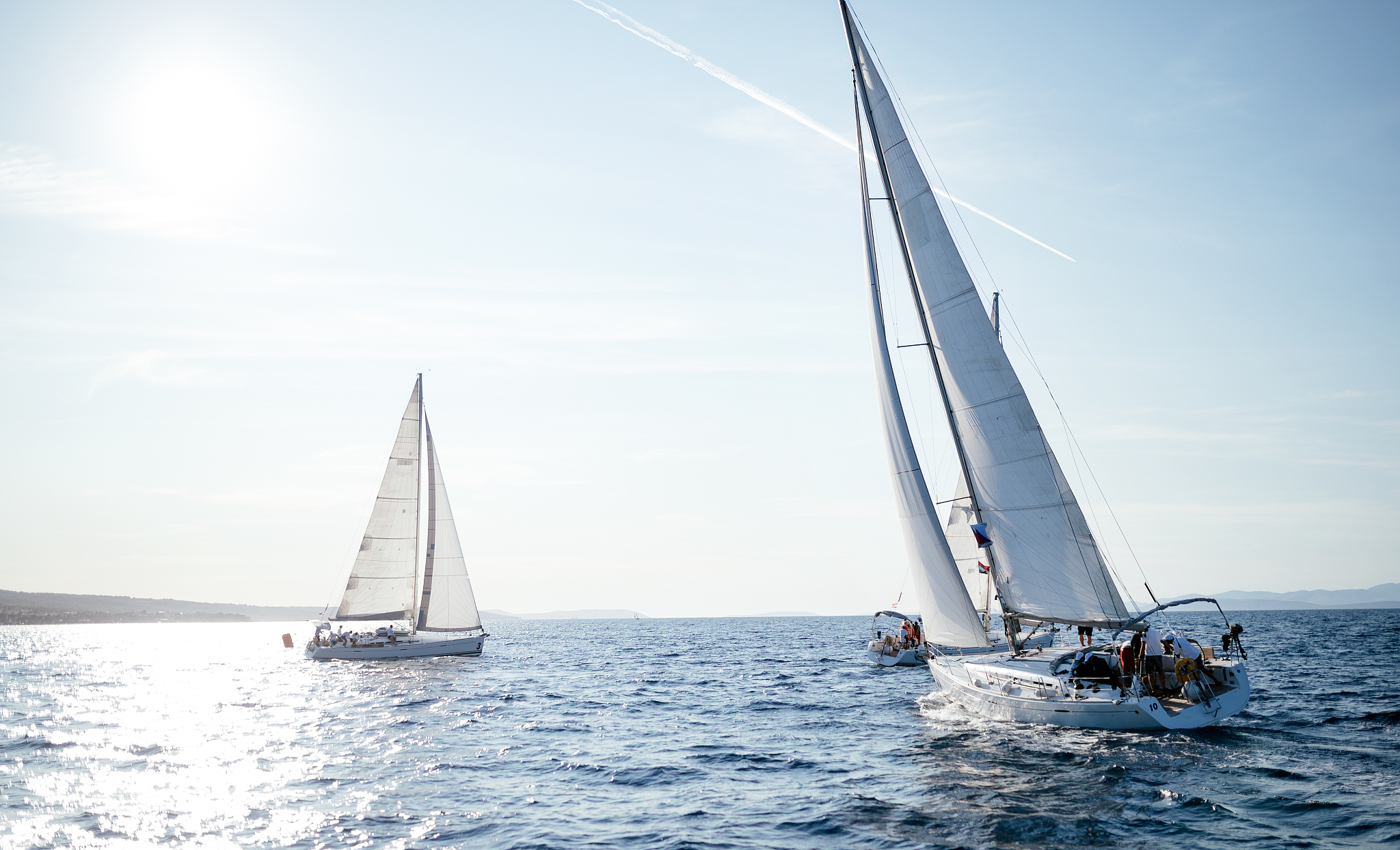 portrait of sailing boats on open sea