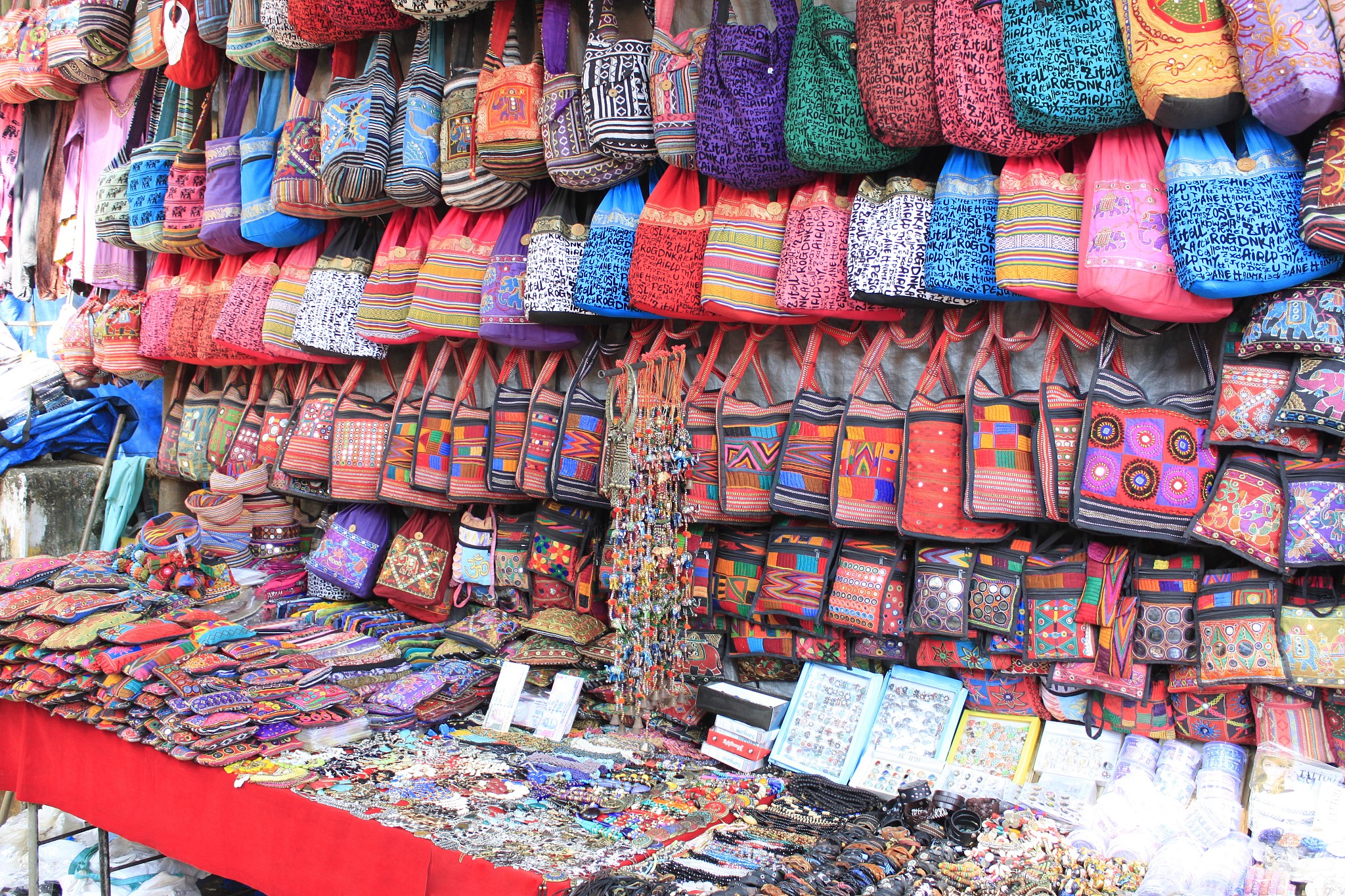 colorful bags and trinkets on display in a shop. goa, india
