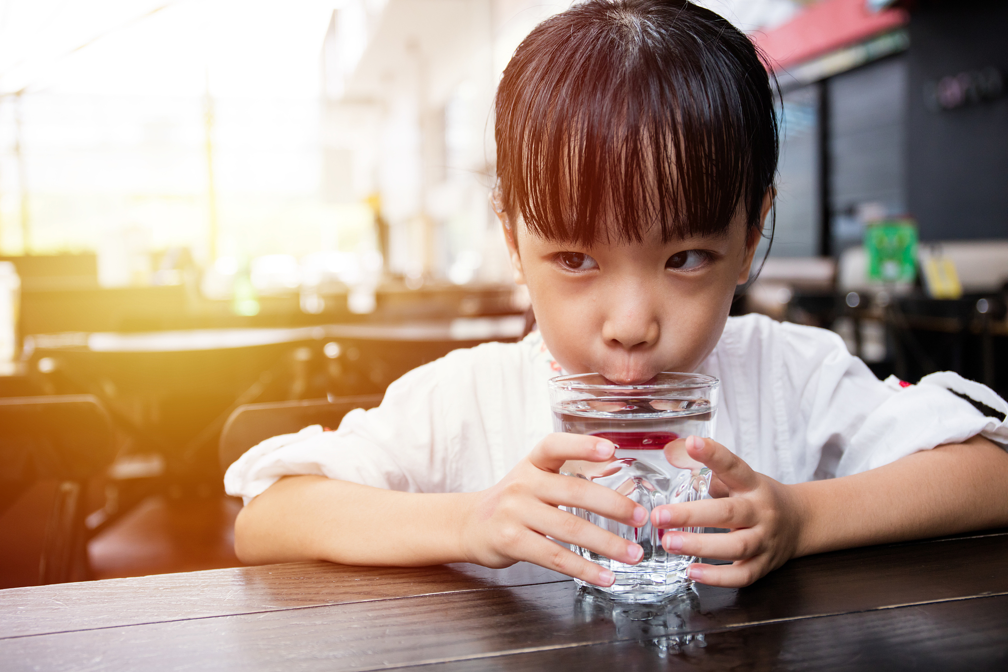 asian little chinese girl drinking water