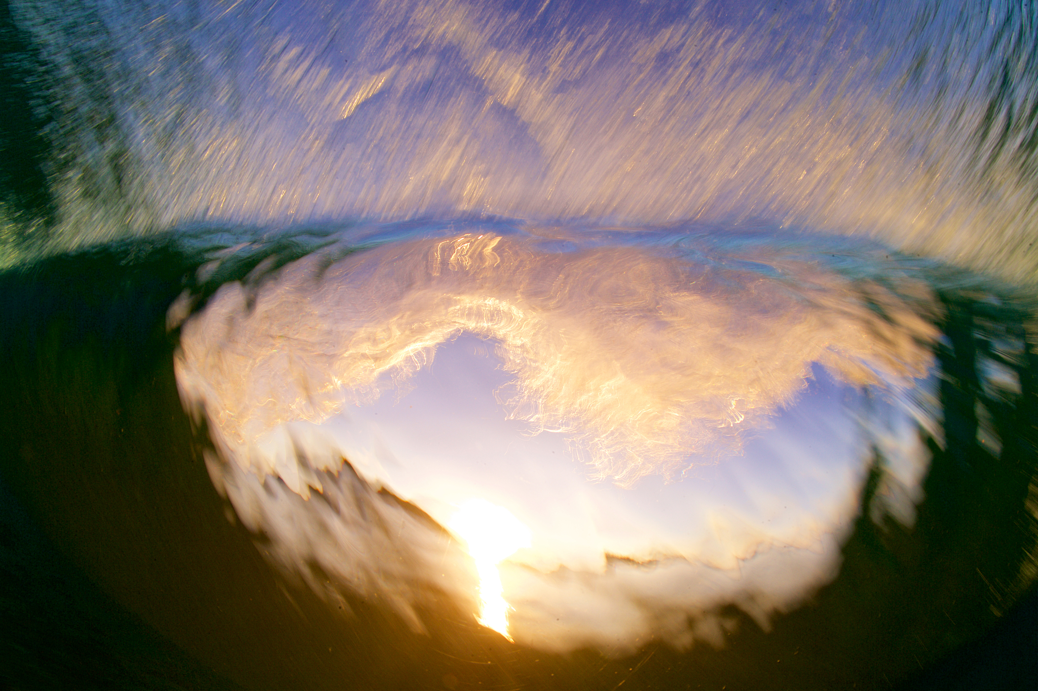 breaking wave framing sunset