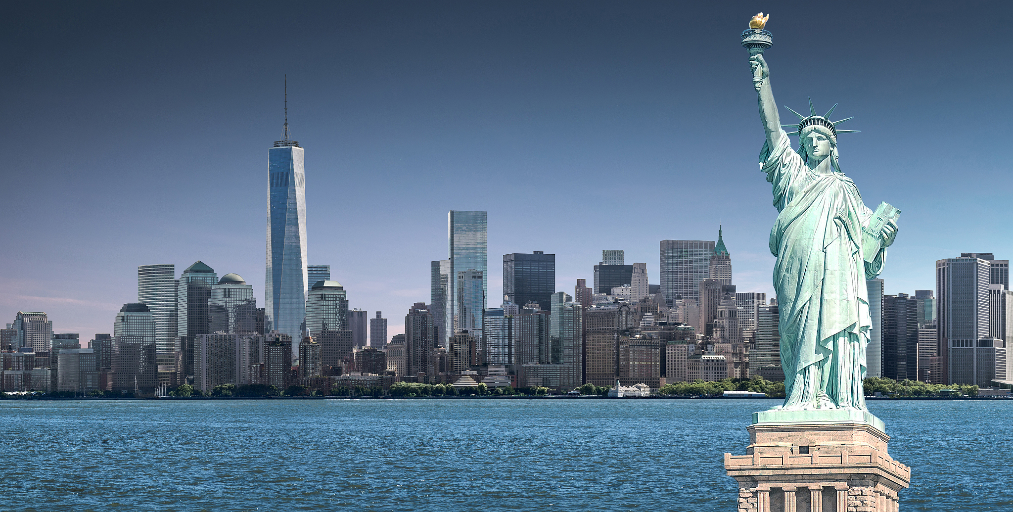the statue of liberty with one world trade center background, la