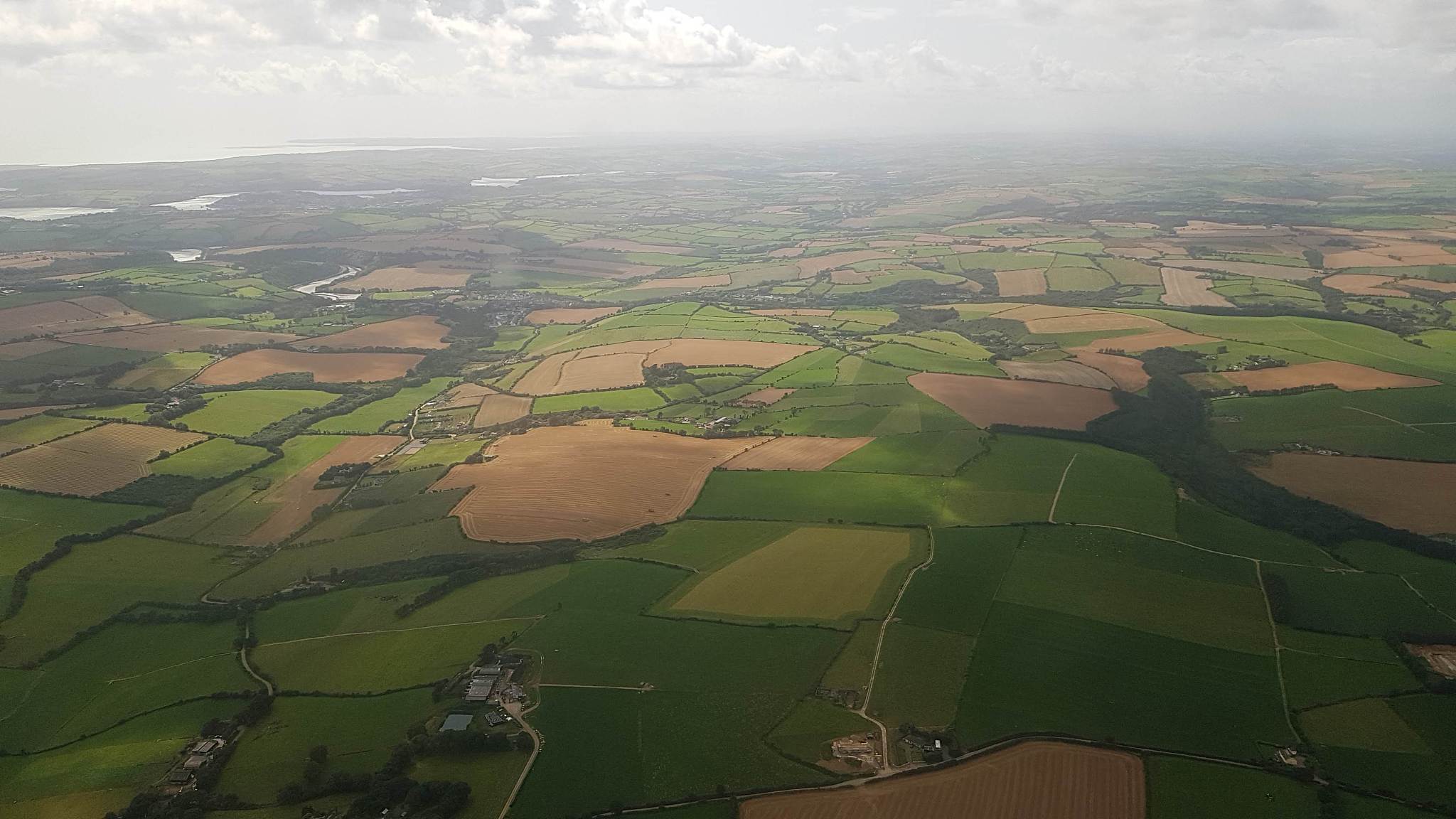 aerial view over ireland's nature and agricultural fields