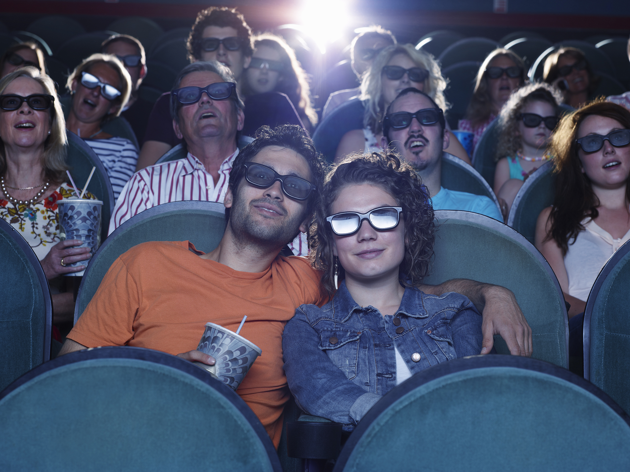 people watching a movie at a theater