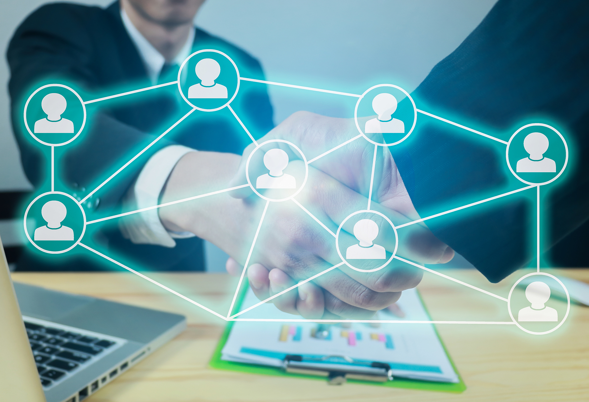 digital composite image of symbols and business people shaking h