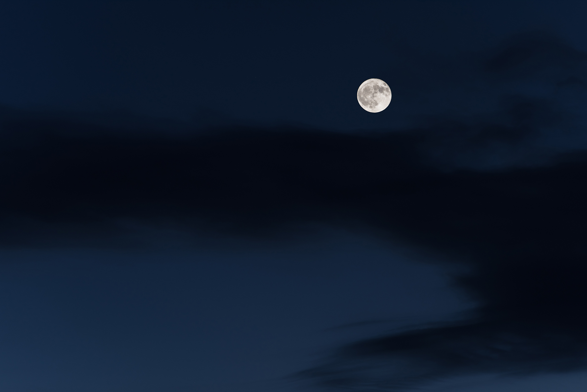 huge full moon on the night sky with bright stars