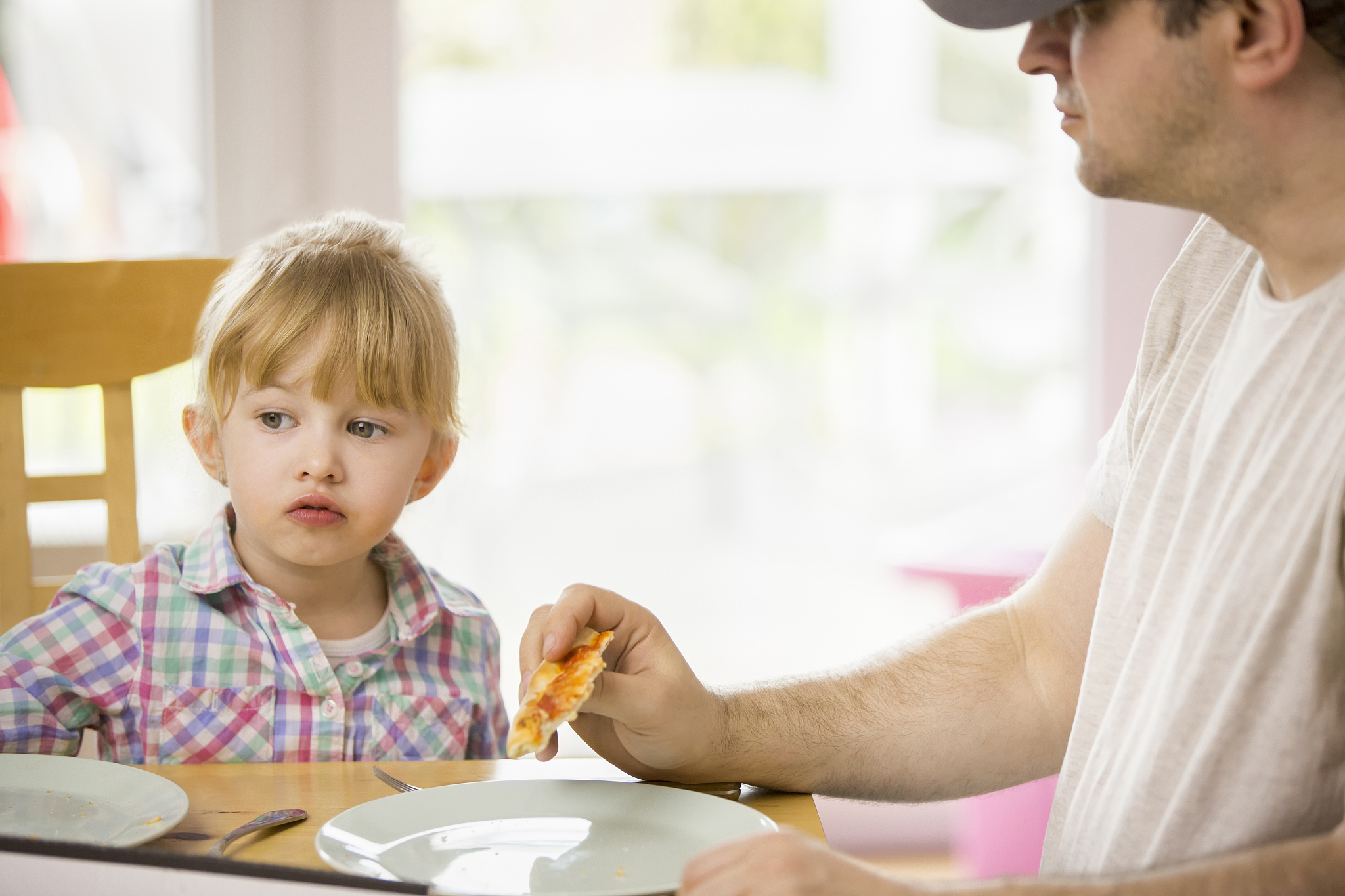 family eating pizza at home out of pizza box