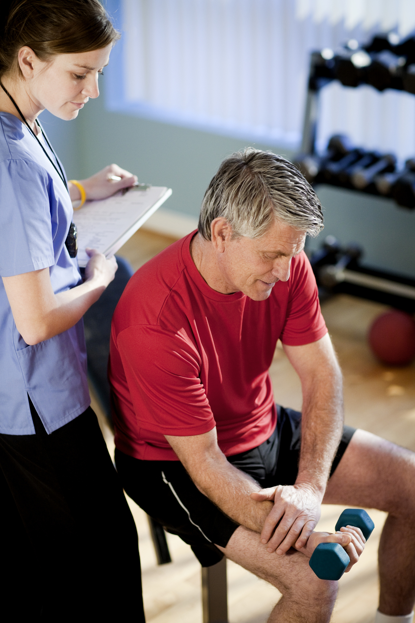 mature man working with a physical therapist