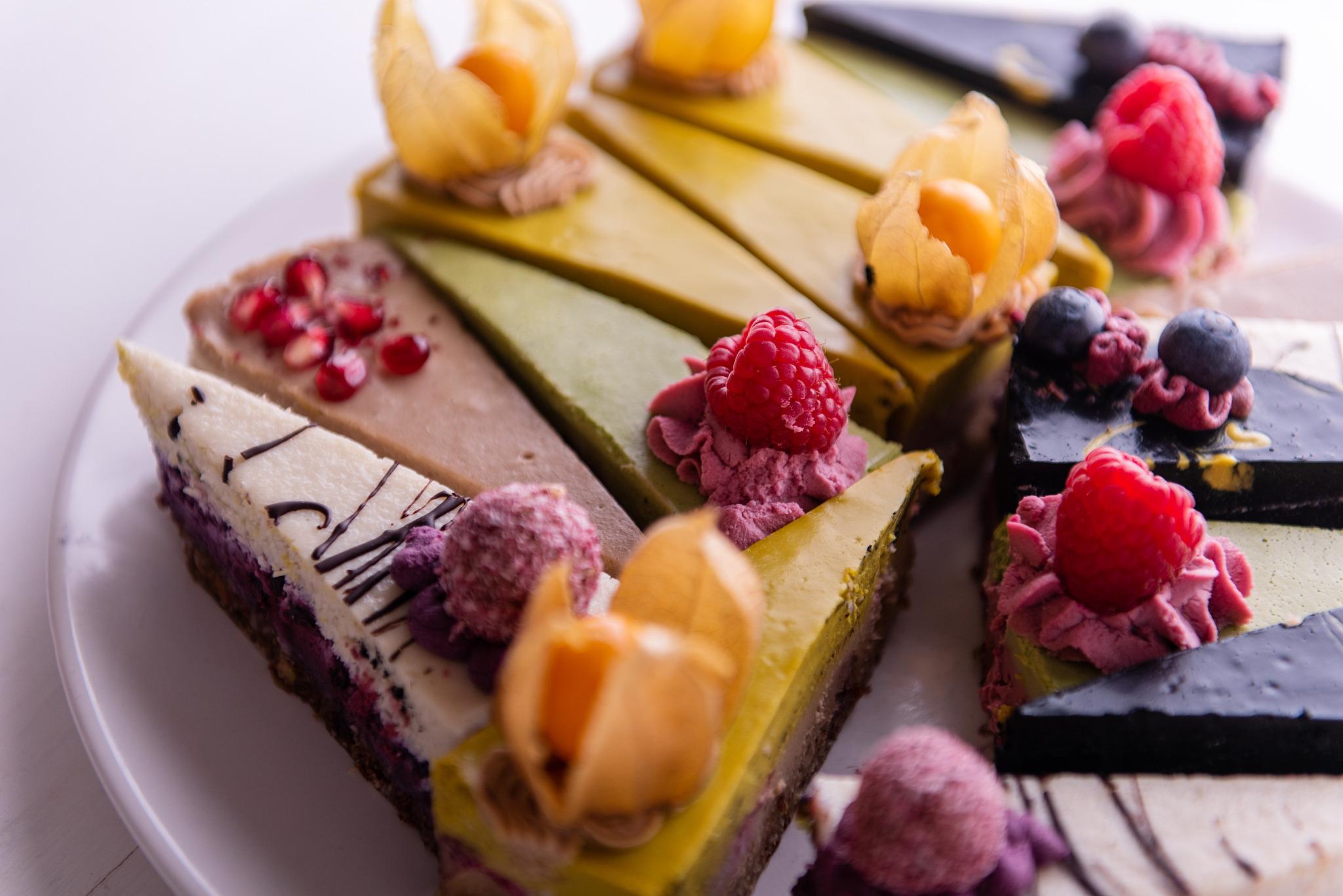 random selection of healthy vegan raw colorful fruit cakes