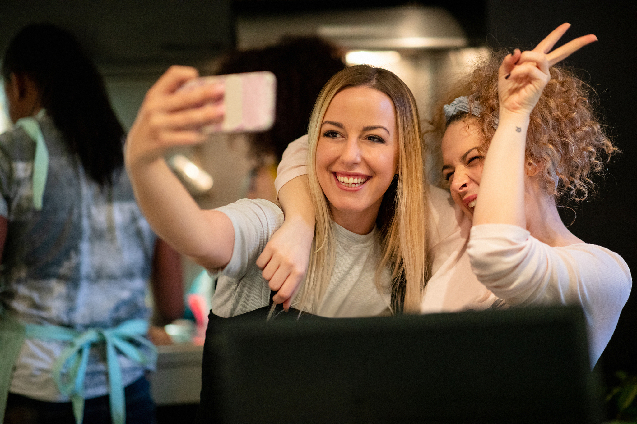 taking a selfie making victory sign with her flatmate in the kit