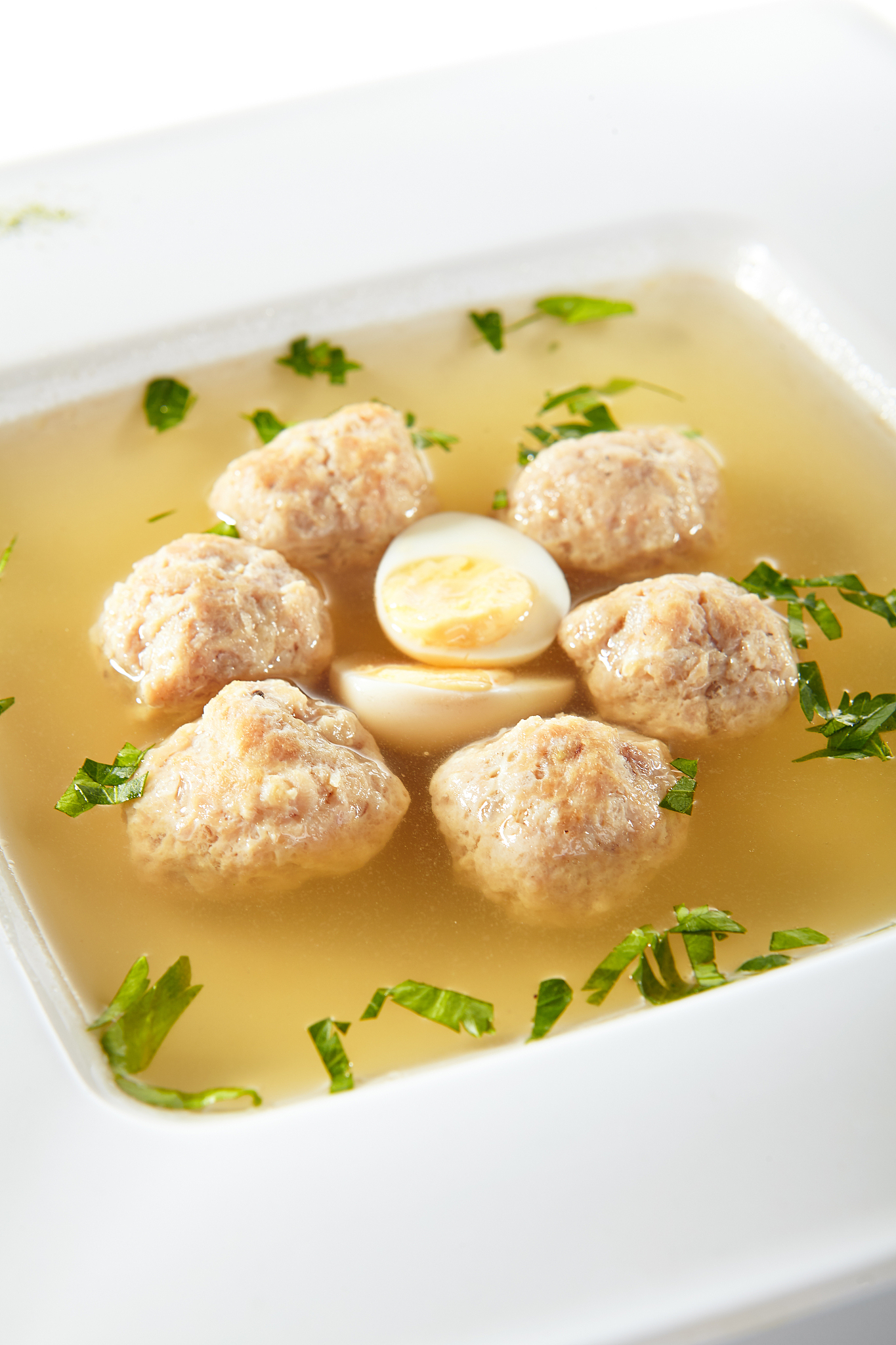 chicken soup with meatballs decorated with boiled quail egg