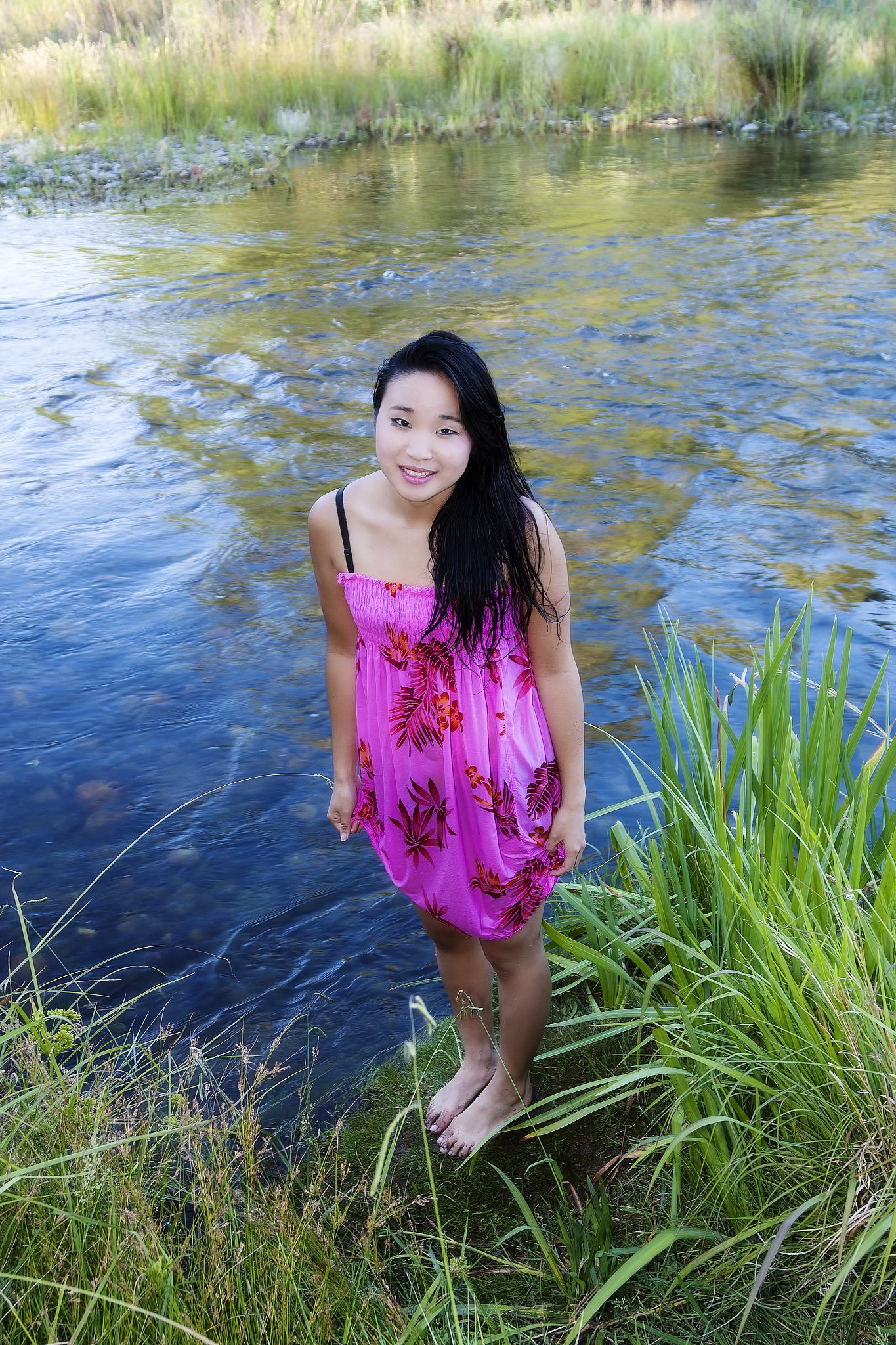 young japanese woman standing on river bank