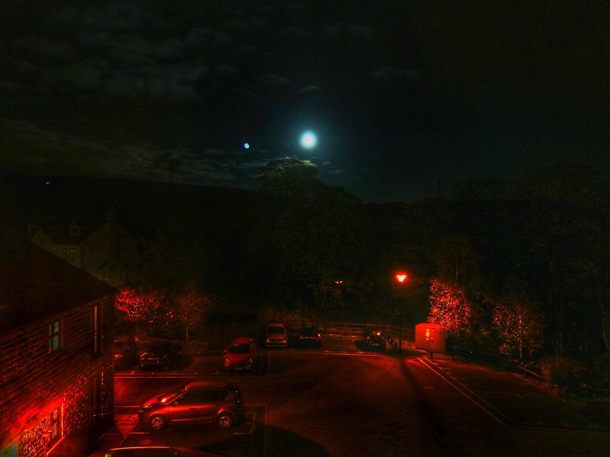 cars on illuminated street at night