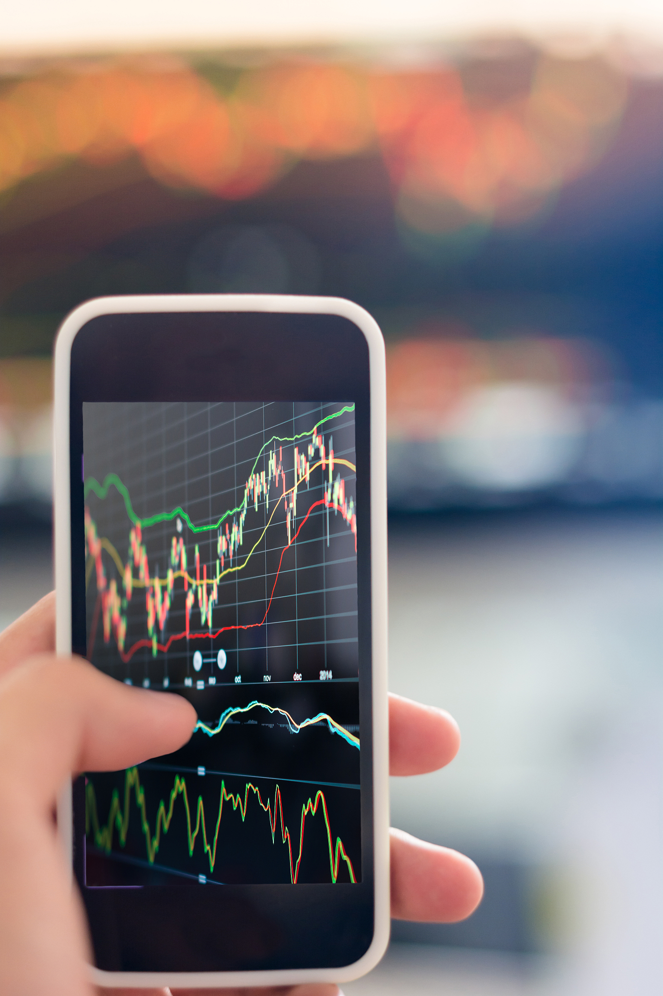 smart phone with stock market graph