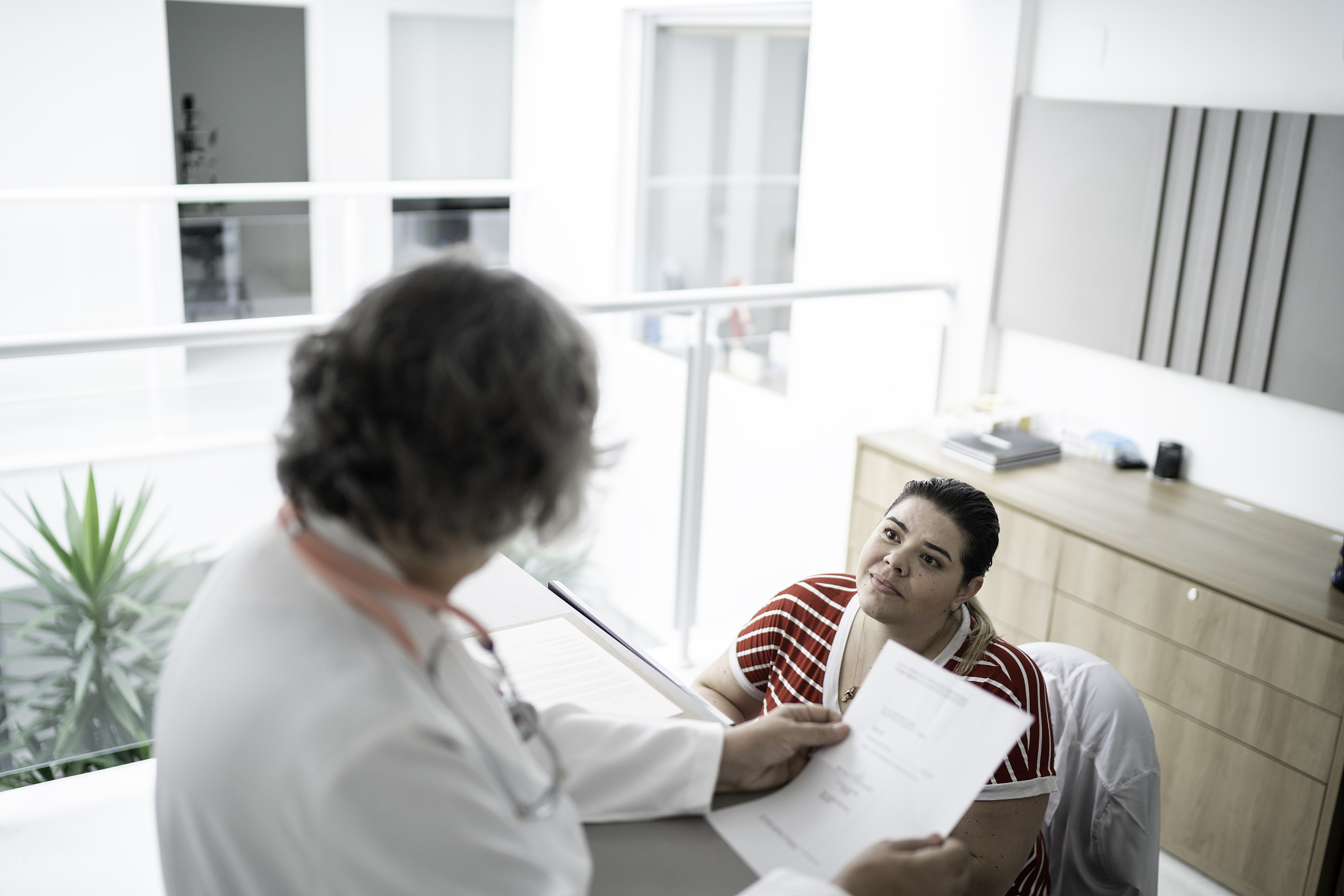 female senior doctor at hospital reception / secretary