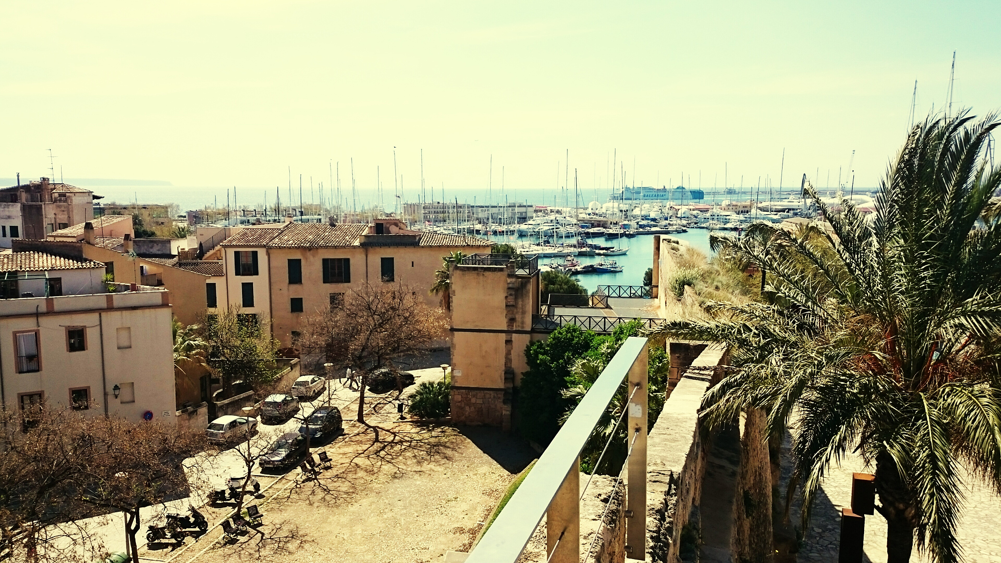 buildings by boats moored at port against sky