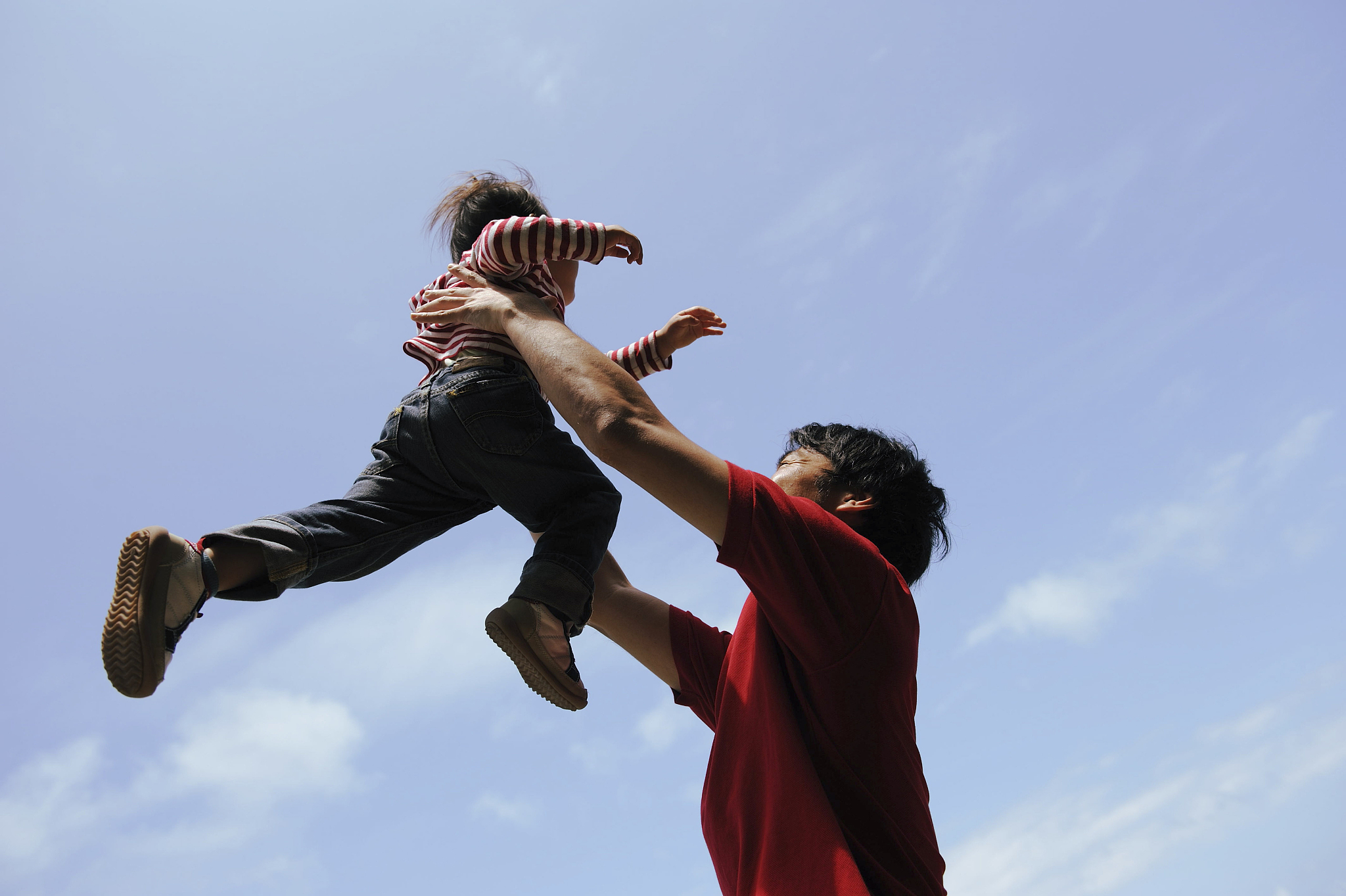 father lifting child into air