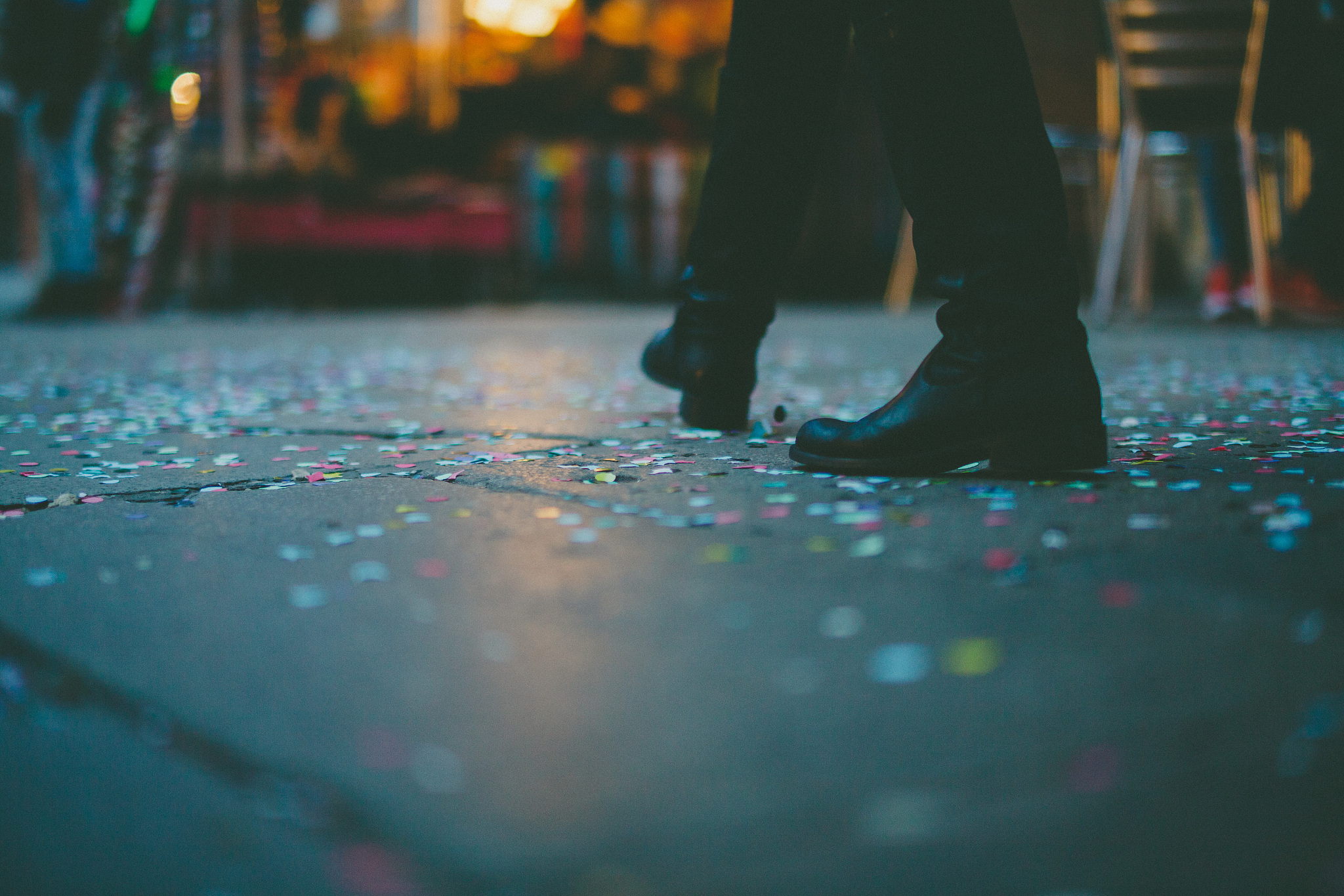 man steps in the street covered by confetti