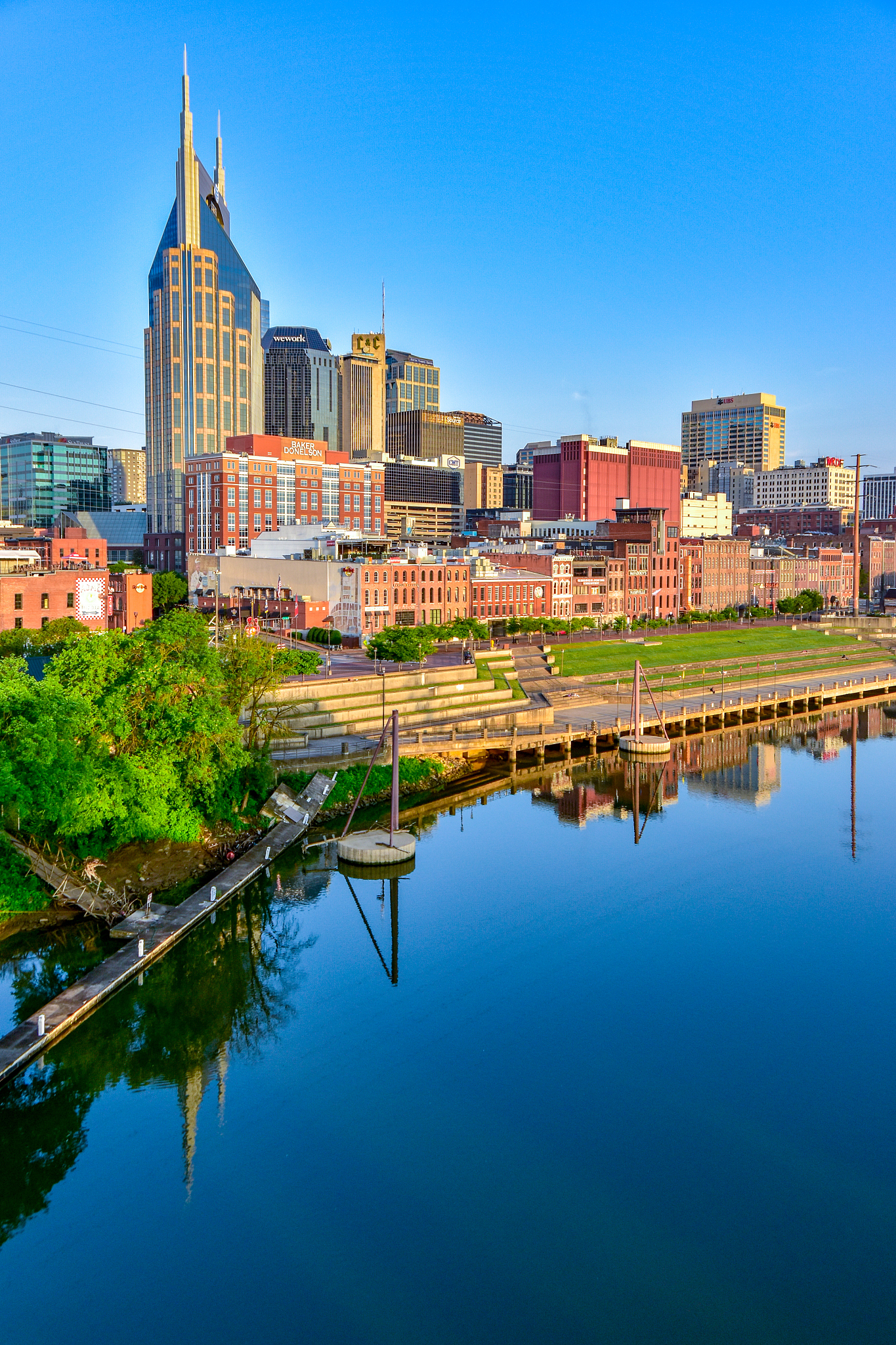 reflection of buildings in river against blue sky