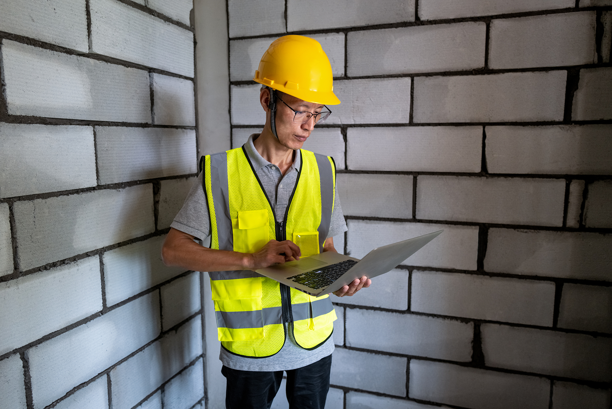 asian middle-aged male construction worker at construction site