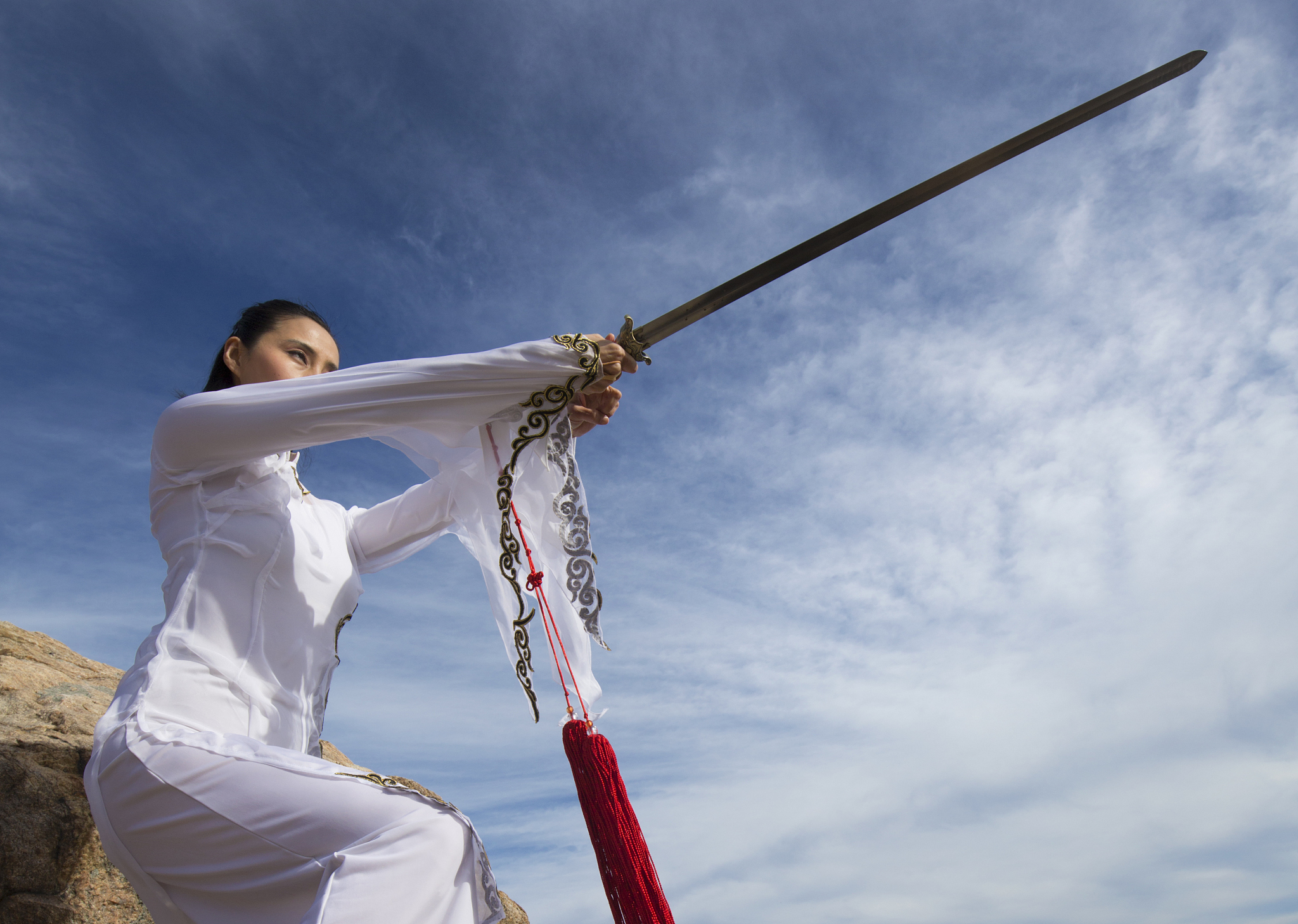 young woman dancer with a sword on a connecticut beach.