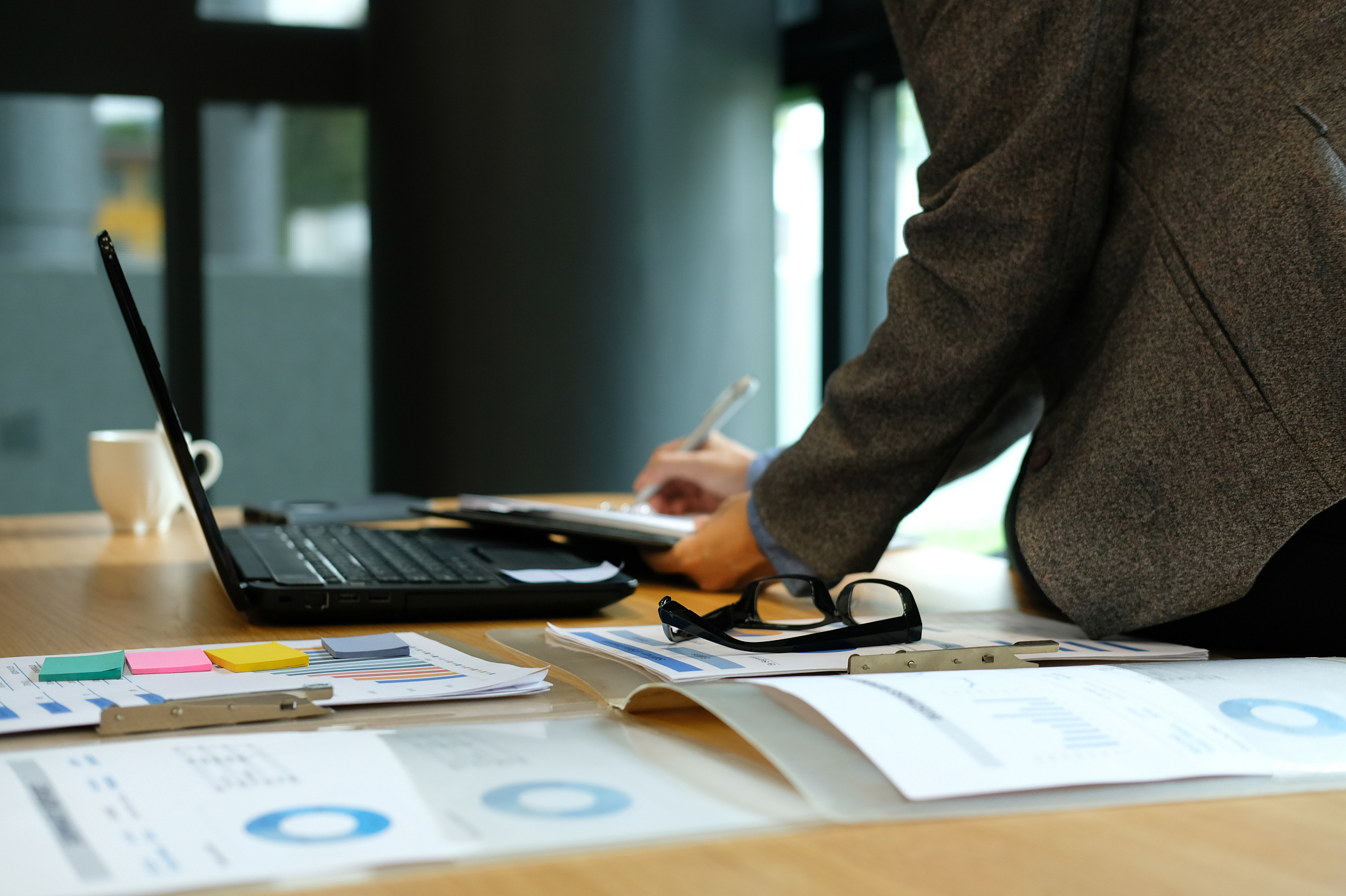 midsection of businessman working on table