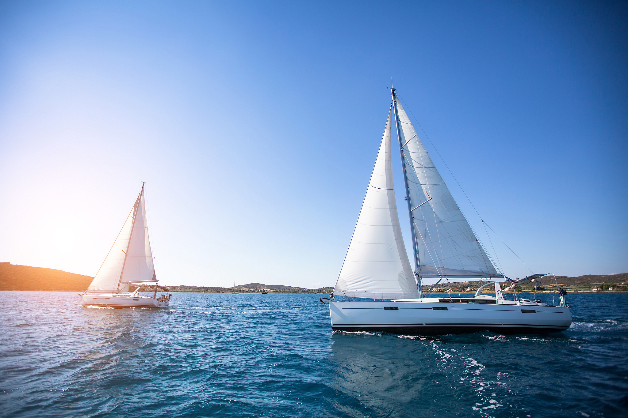 sailing in the wind through the waves at the sea.