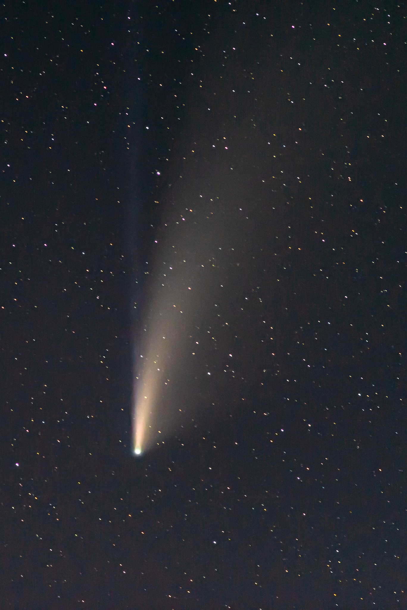 comet neowise twin tails glowing in the night sky. telephoto vie