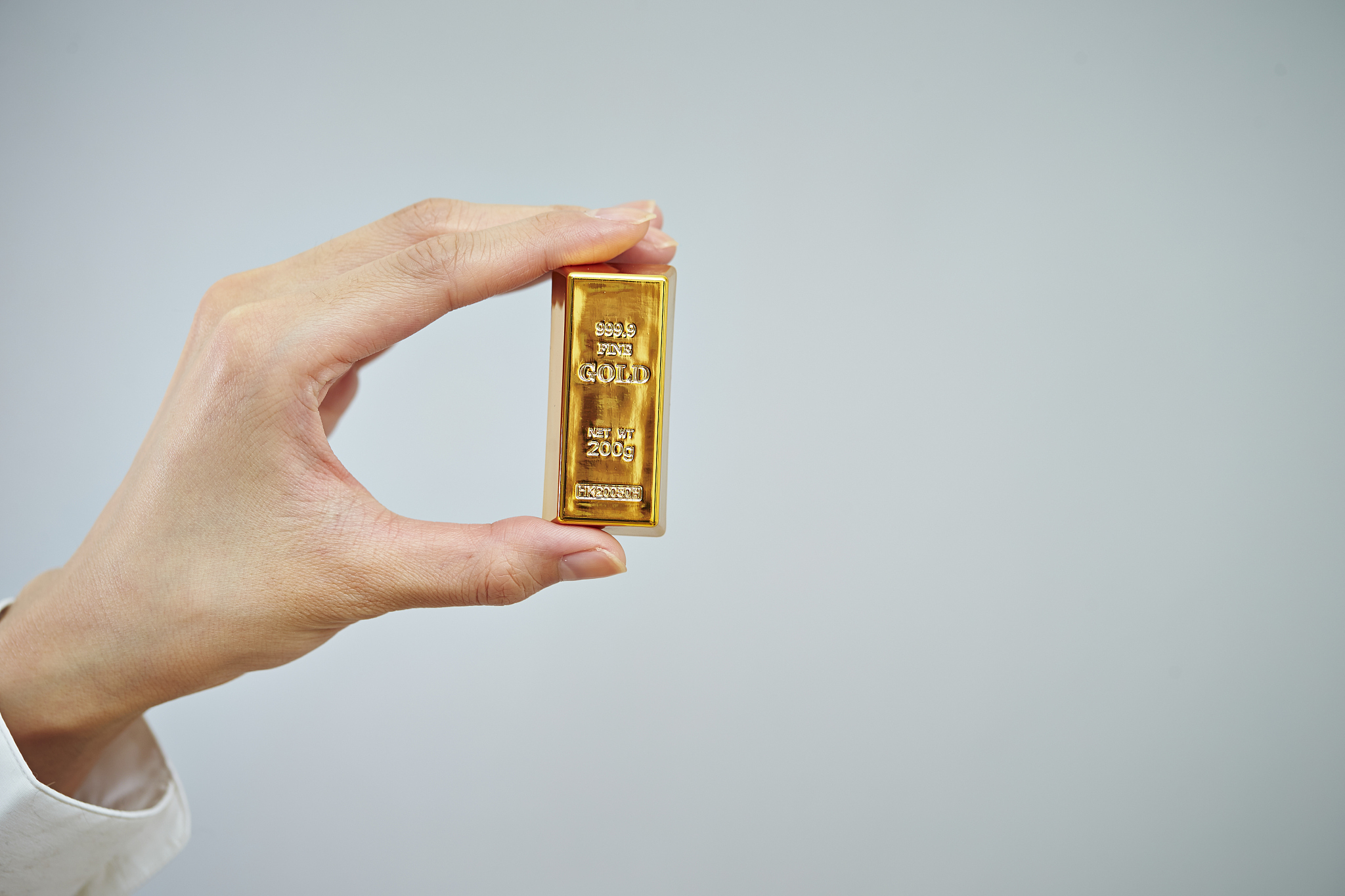 gold bar with hand