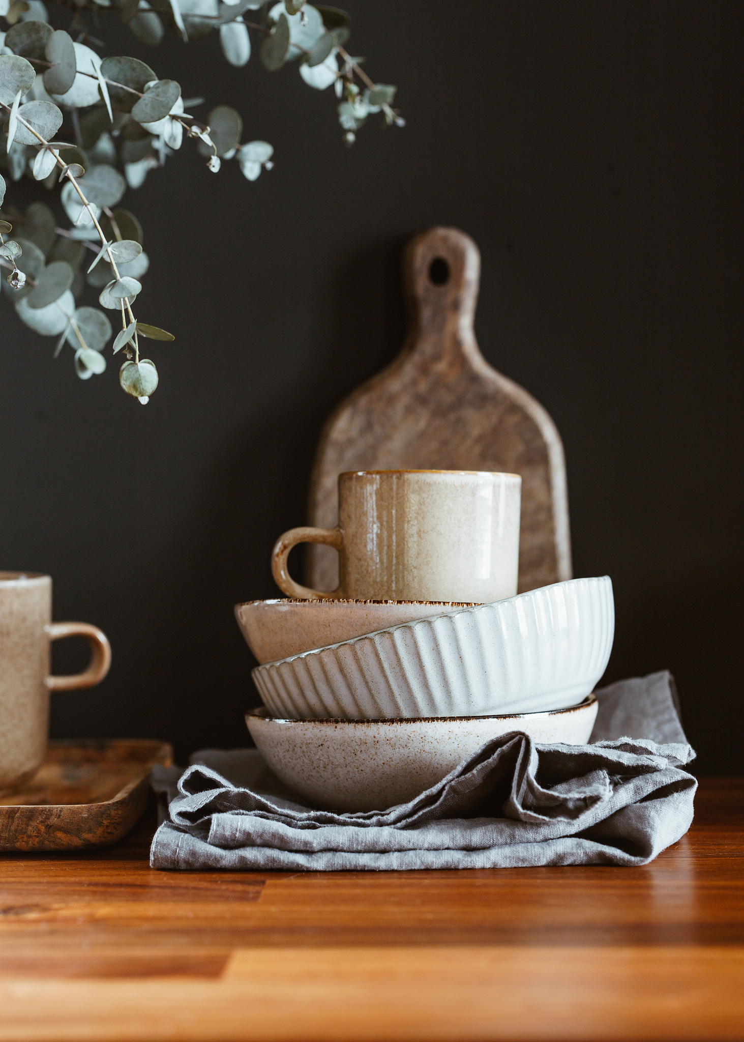 set of kitchen ceramic tableware and wooden cutting boards on a 