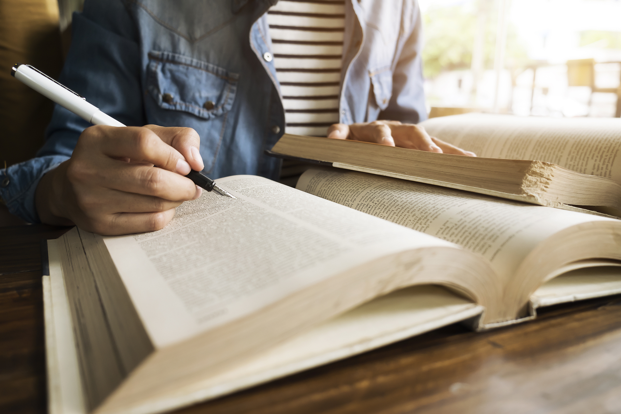 woman reading book in library.