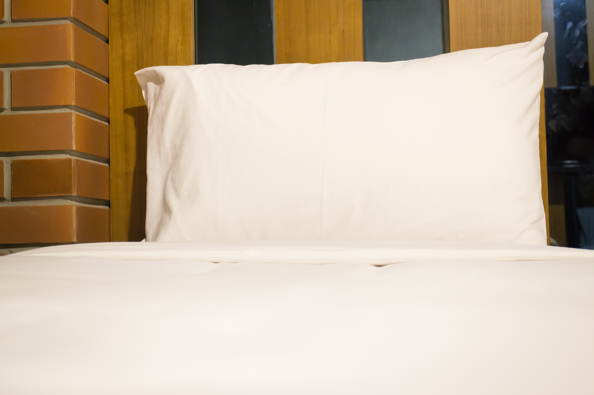 white bedding sheet and pillow