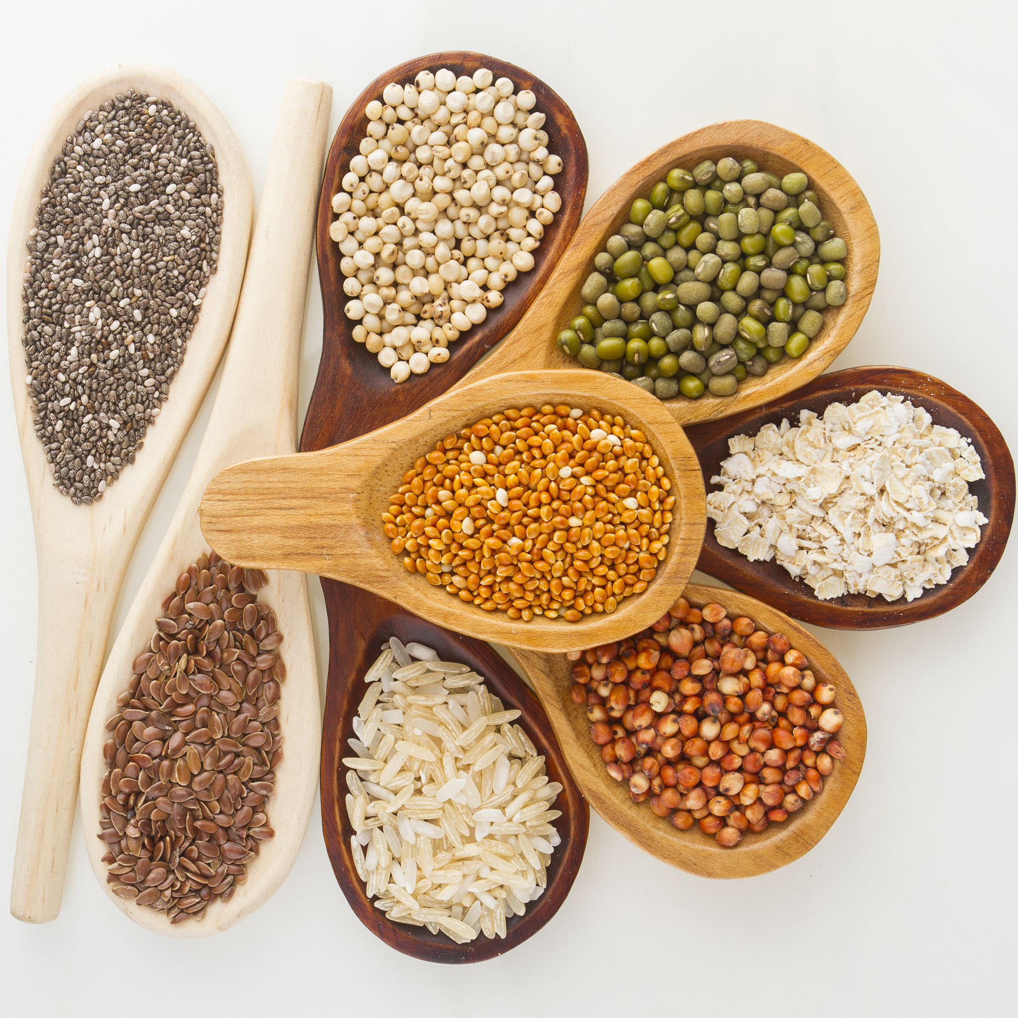 wooden spoons with assorted grains of super foods, gluten free